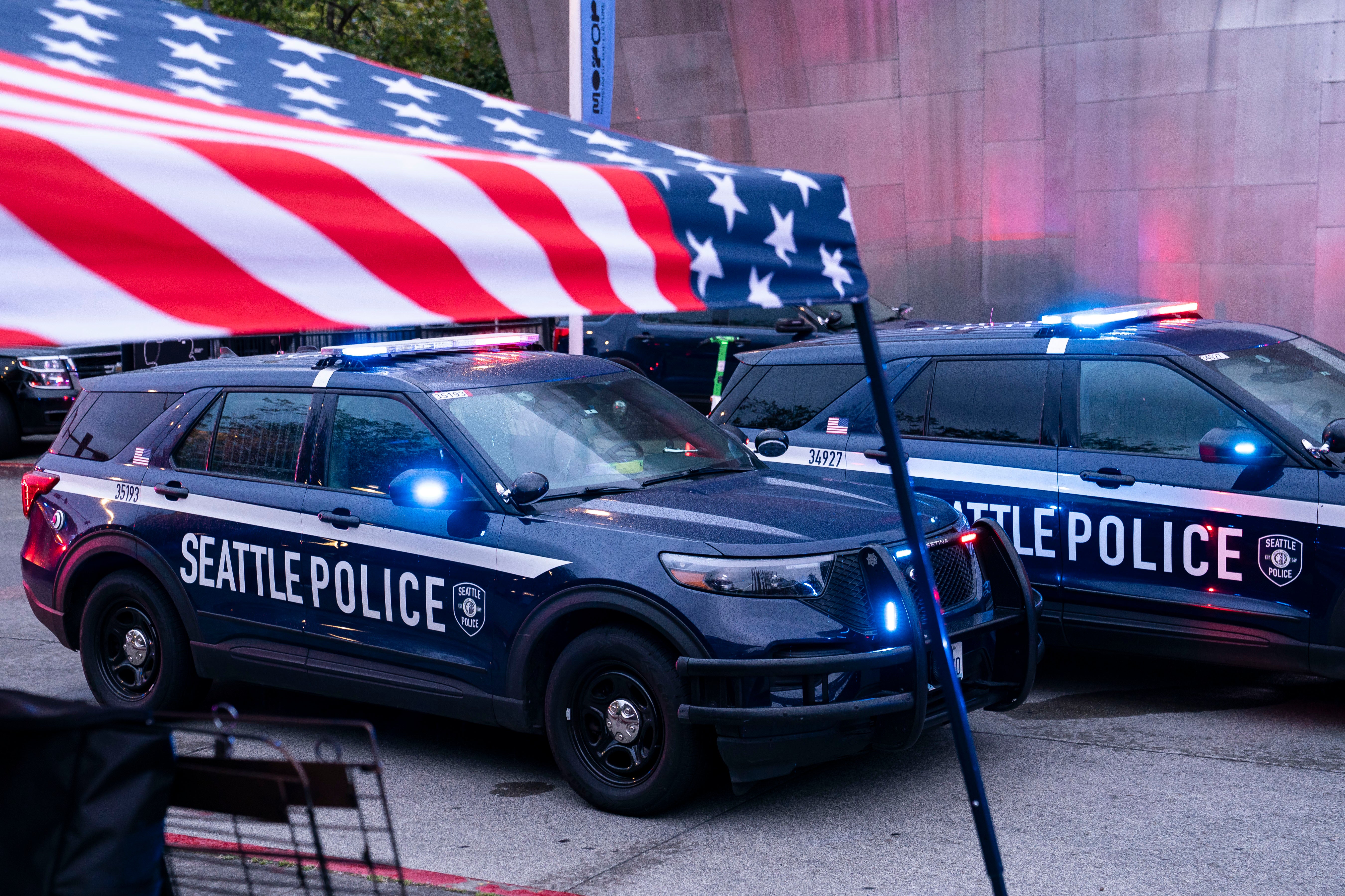 Police vehicles are parked next to a vendor tent following a mass shooting at the Bite of Seattle food festival on 26 July 2026 in Seattle, Washington