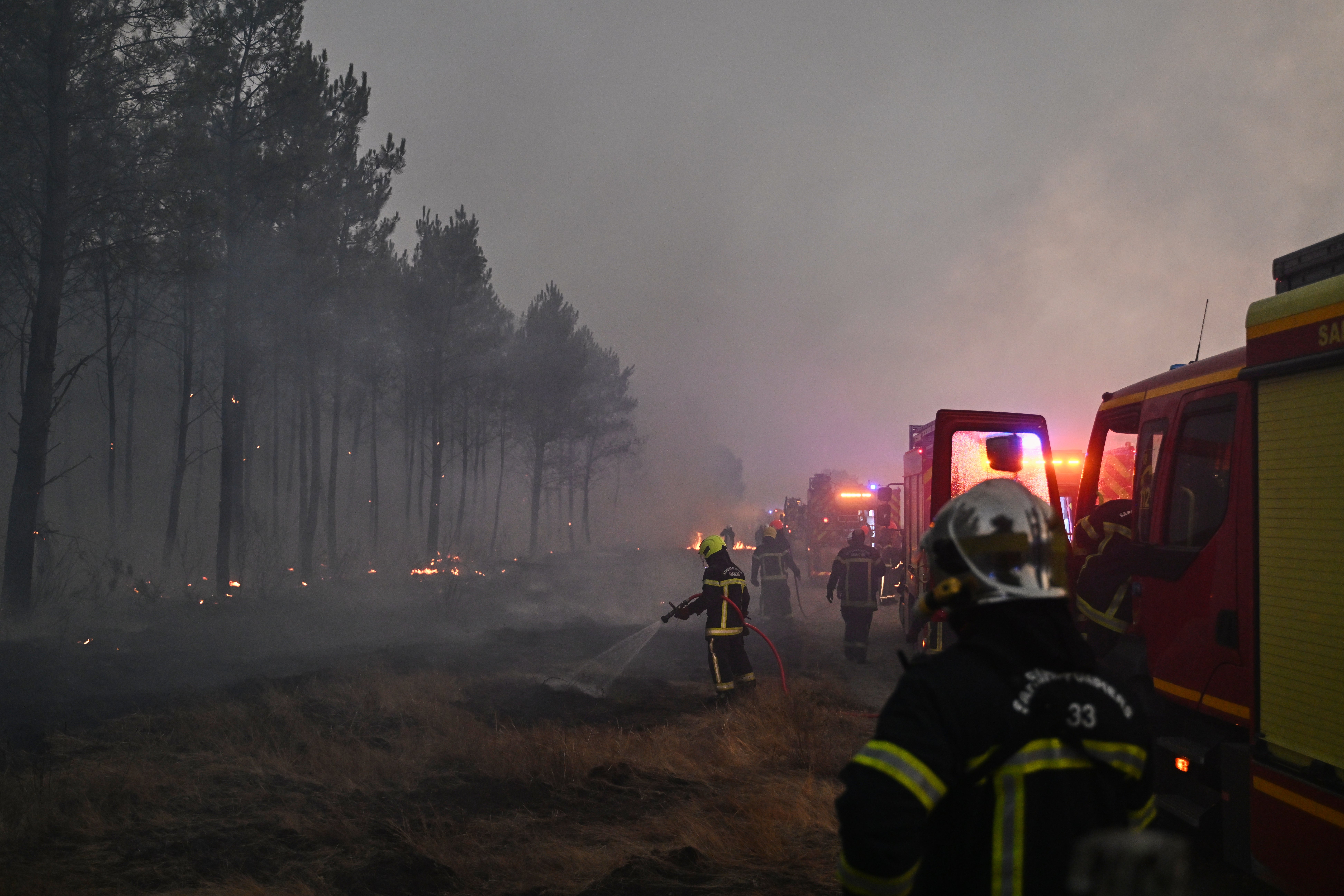 Firefighters battle a wildfire near Marcheprime, France