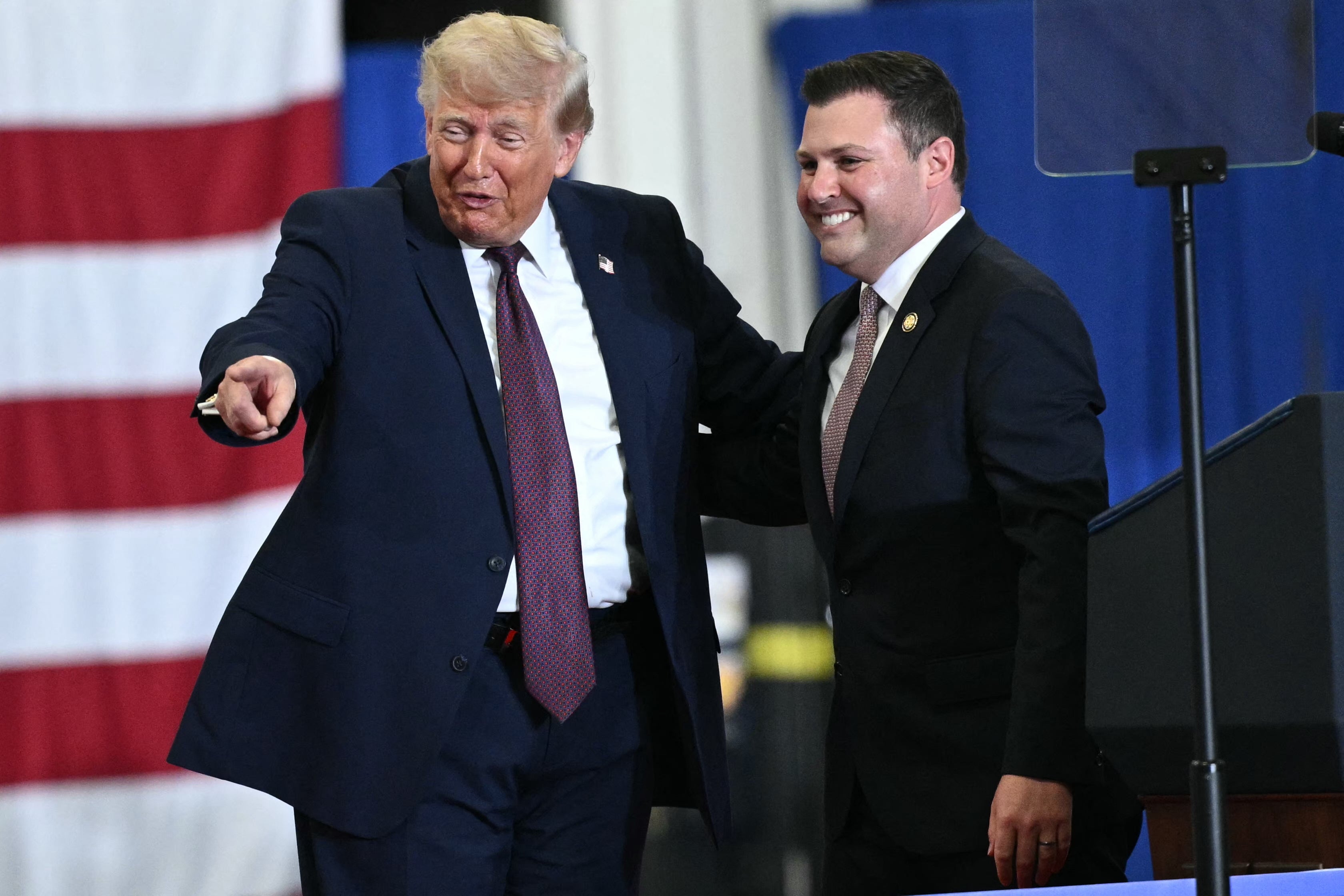 Trump appears on stage with US Representative Ryan Mackenzie, Republican of Pennsylvania, during a visit to the Mack Trucks manufacturing facility in Macungie, Pennsylvania, on June 23, 2026