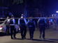 Manhunt for gunman after six injured in Chicago shooting that left two fighting for life