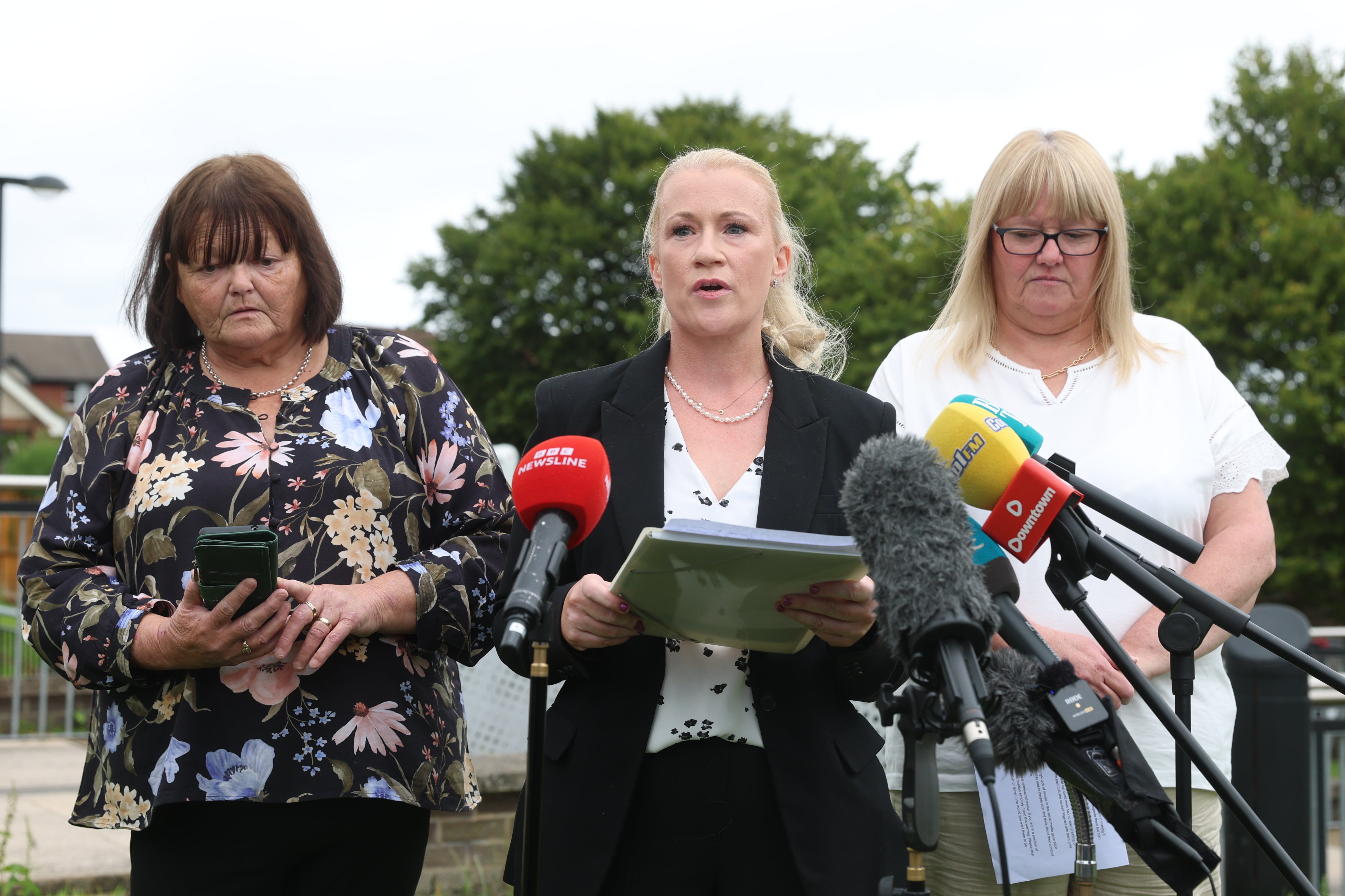 PSNI Detective Chief Inspector Claire McDonald (centre) with family members of affected patients, Tanya (right) and Shirley, outside Craigavon Crown Court (Liam McBurney/PA) (PA Wire)