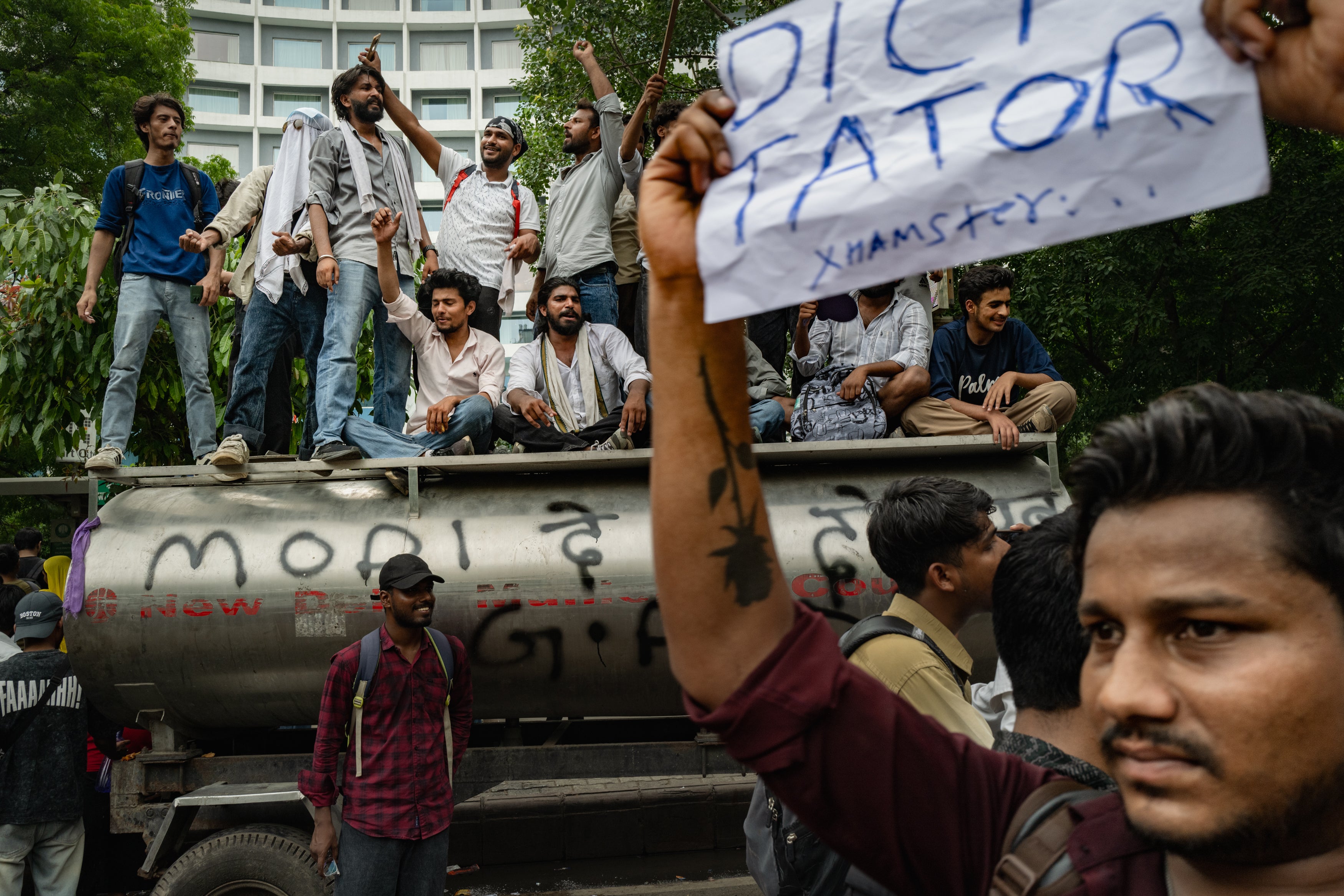 Supporters of India's Cockroach Janta Party (CJP) celebrate following the resignation of Education Minister Dharmendra Pradhan, after days of protests demanding he step down over the alleged NEET examination paper leak scandal