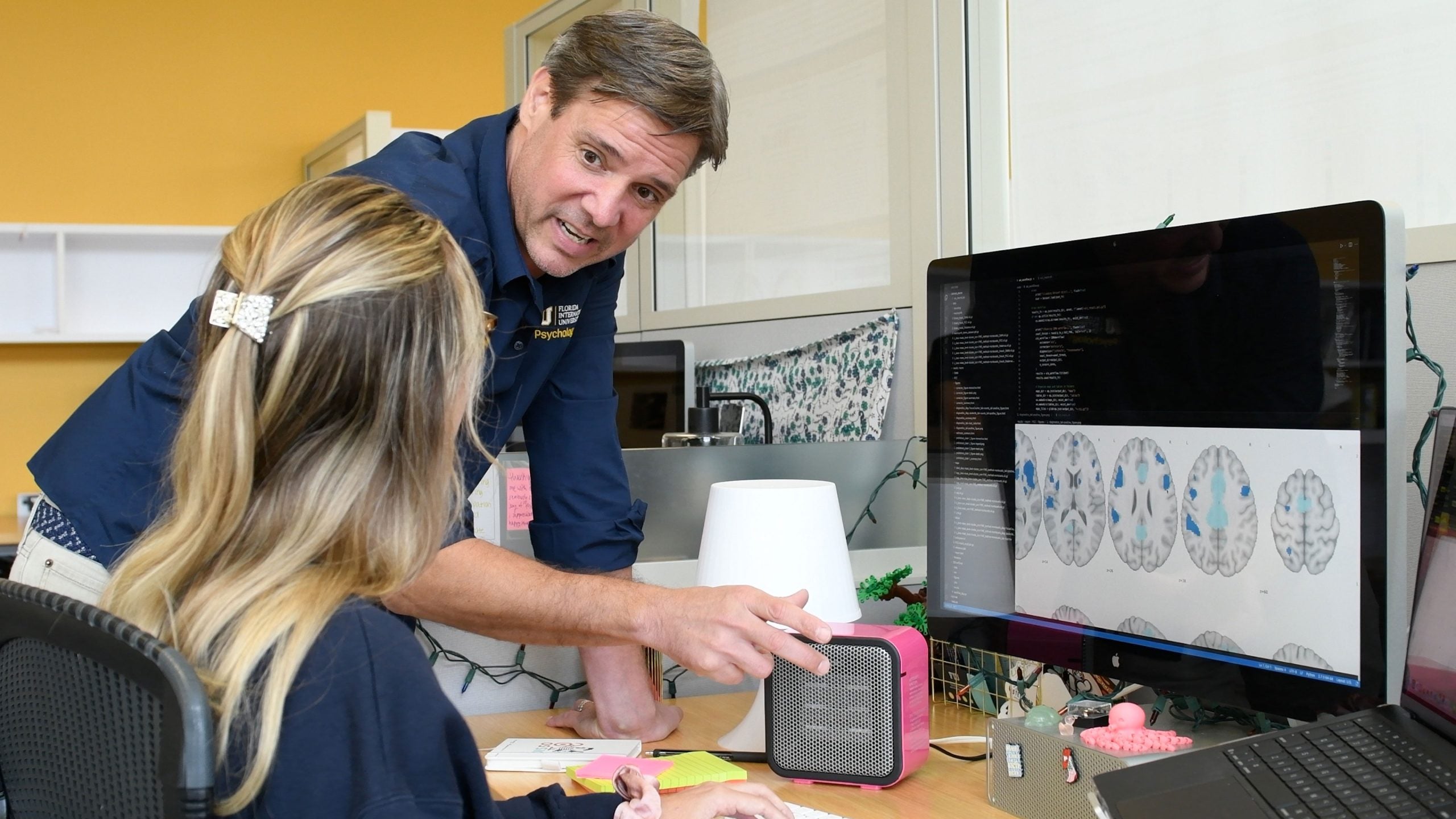Matthew Sutherland, director of Florida International University’s Neuroinformatics and Brain Connectivity Lab and Chloe Hampson, a graduate student co-author of the study review brain images of regions communicating with brain areas showing structural changes linked with sleep disorders