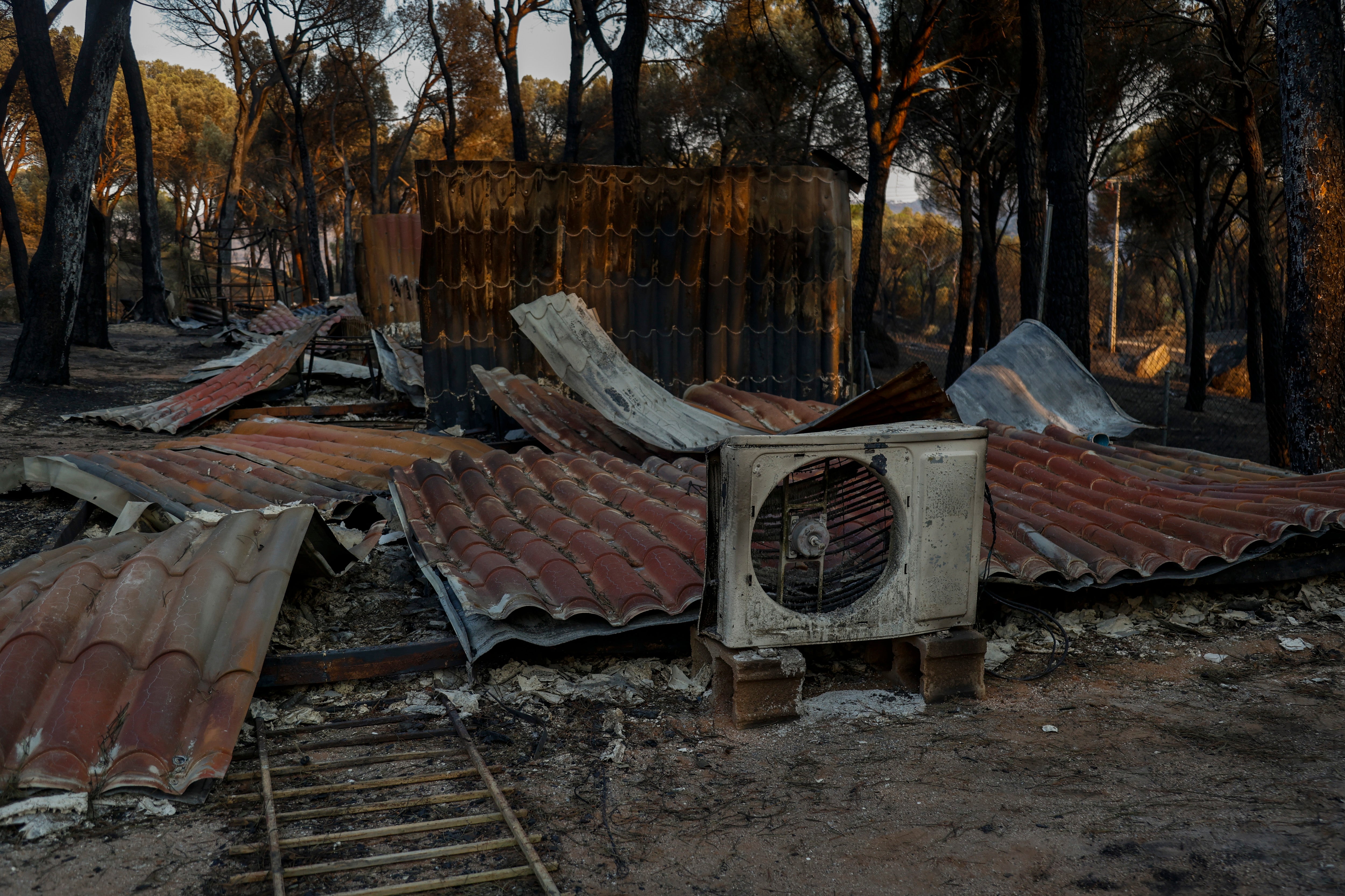 Camping La Ardilla Roja is burnt out next to Pantano de San Juan following wildfires (Getty)