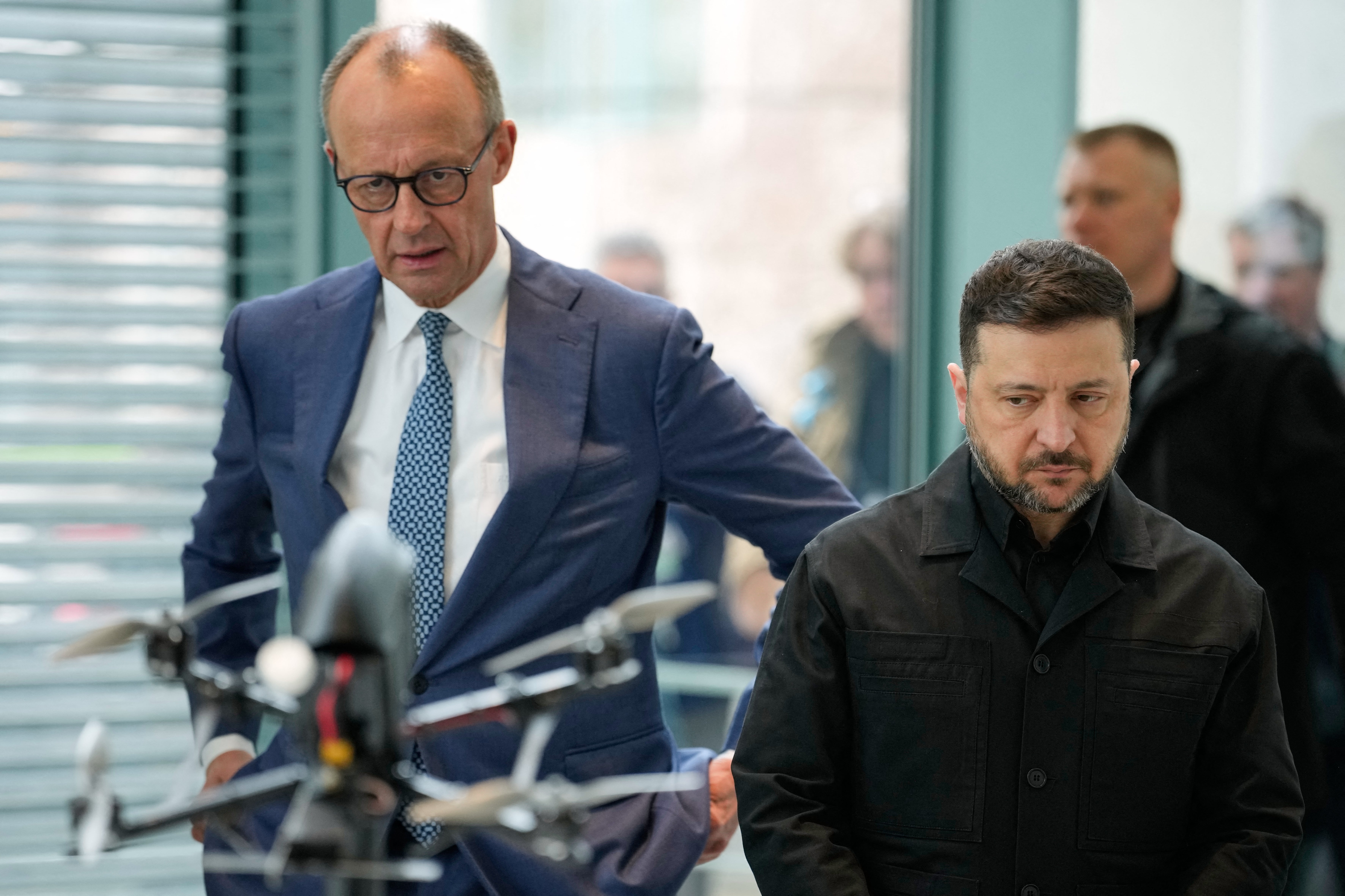 German Chancellor Friedrich Merz (L) and Ukrainian President Volodymyr Zelensky watch a presentation of drones made in German-Ukrainian cooperation during a visit at the Chancellery in Berlin (AFP/Getty)