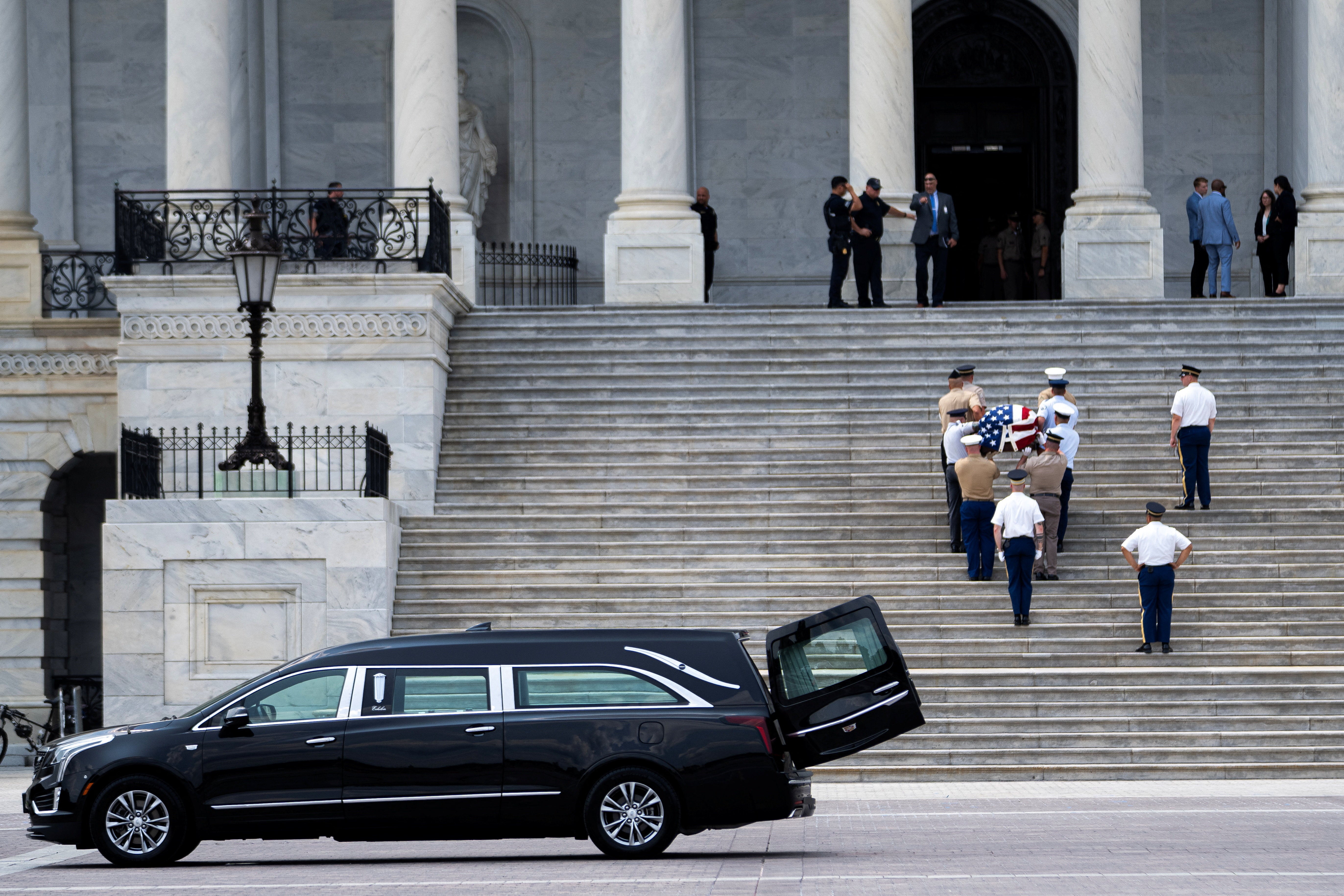 Members of a military honor guard carry an empty, flag-draped casket during rehearsals ahead of the next day's memorial for Graham (Reuters)