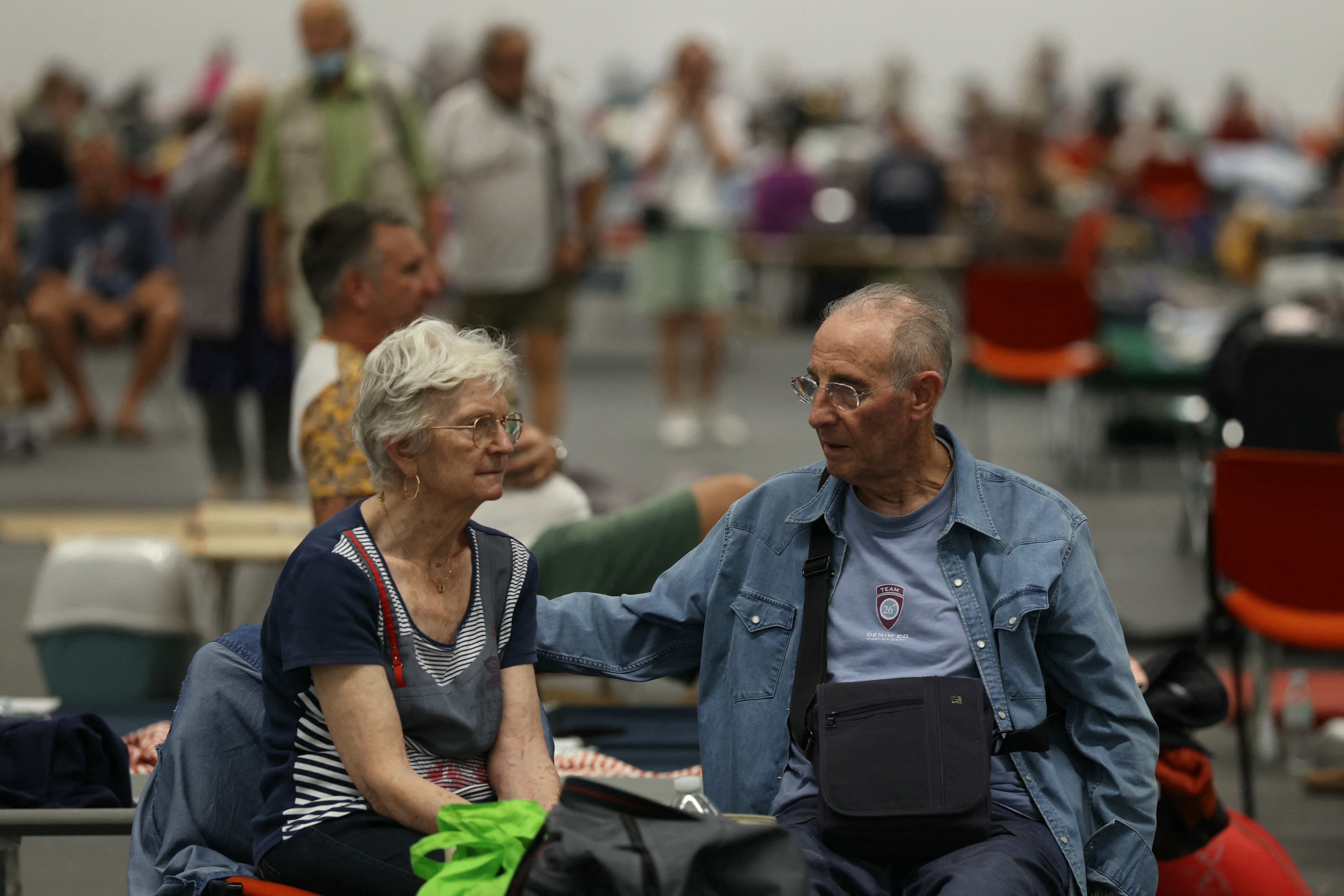A couple evacuated due to the wildfires shelter at the Parc des Expositions de Bordeaux in Bordeaux, on July 25, 2026.