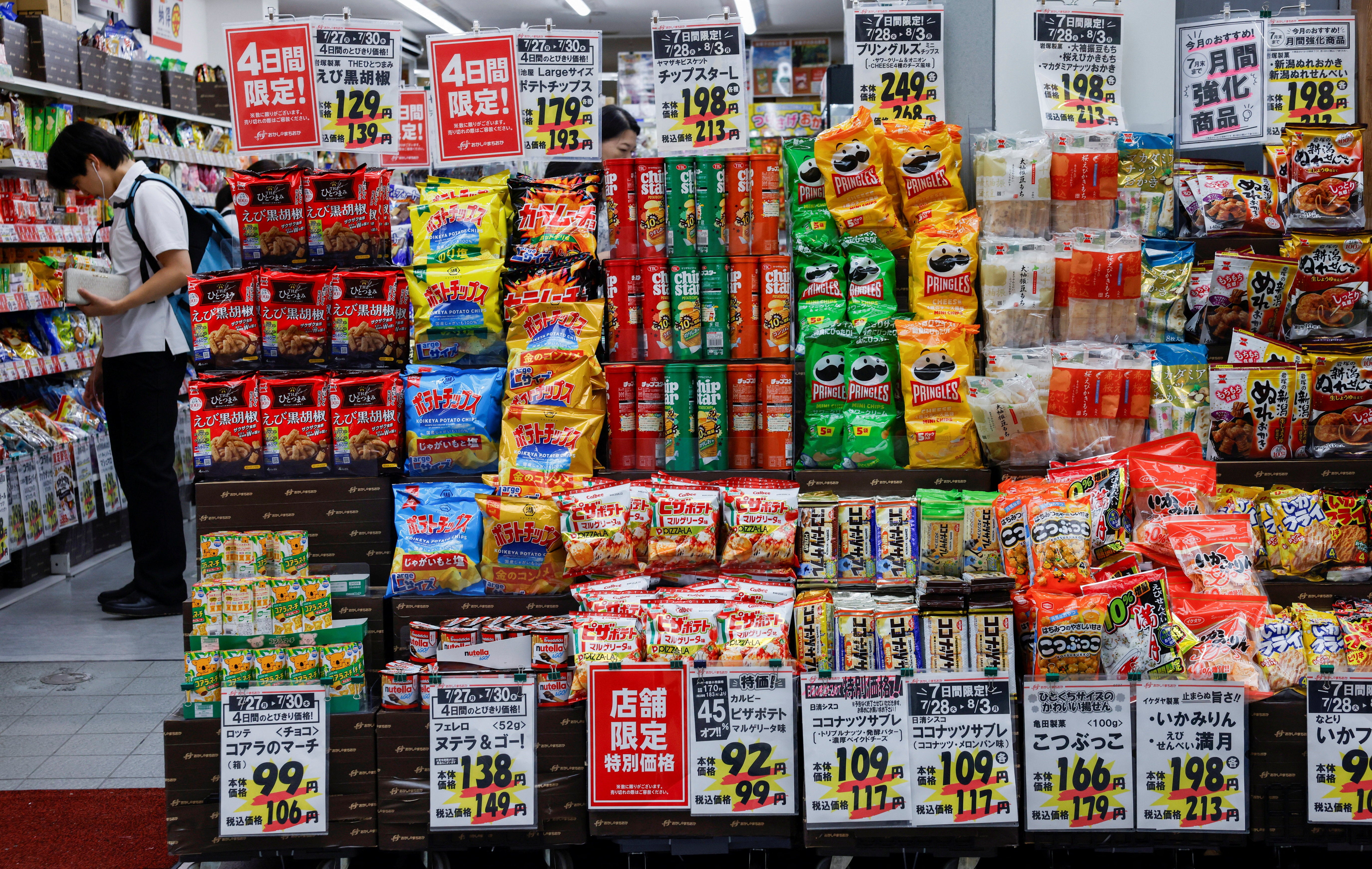 People shop for snacks at a confectionery store in Tokyo, Japan (Reuters)