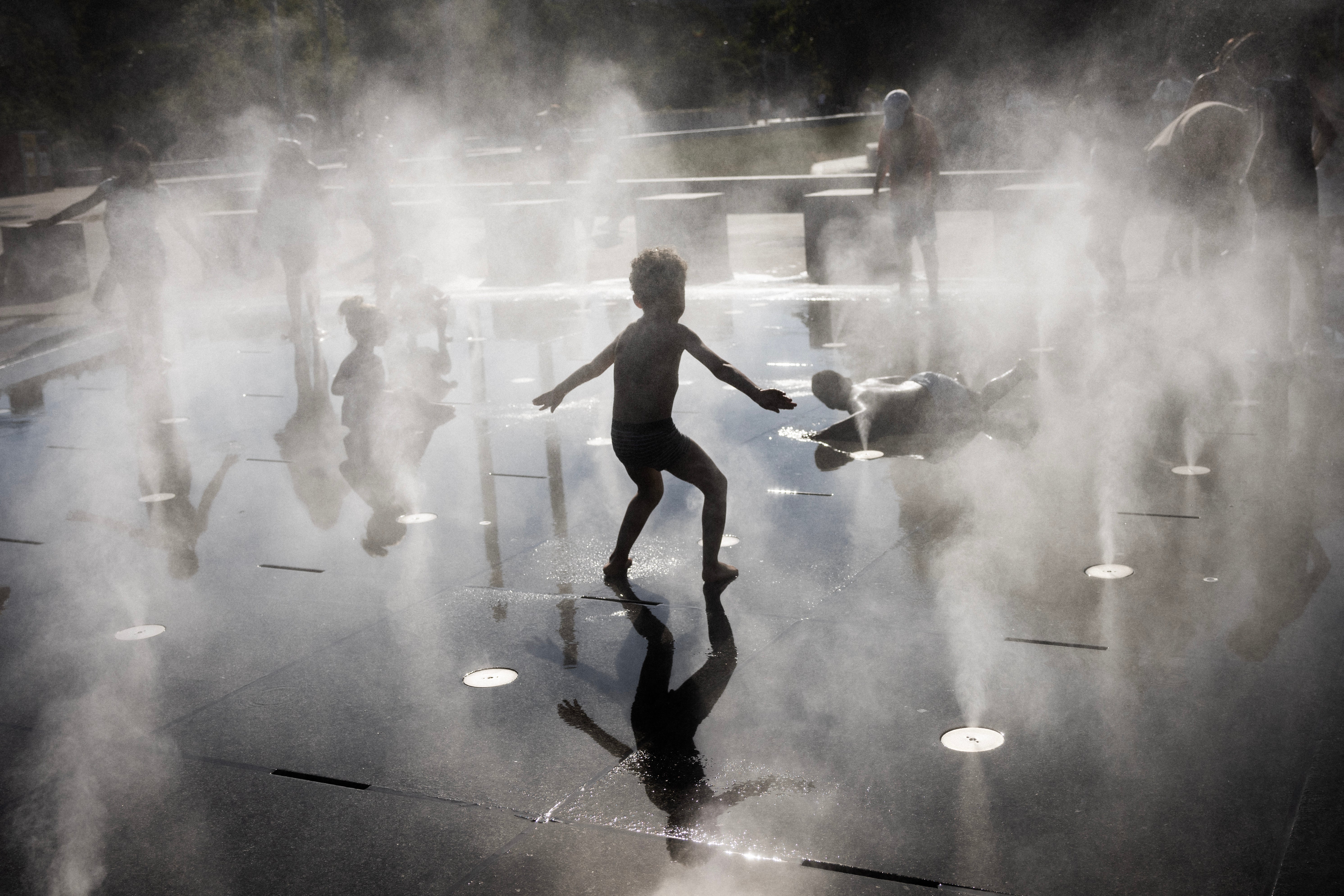 Children play in a splash pad during a heatwave in Paris on July 10, 2026. (AFP/Getty)