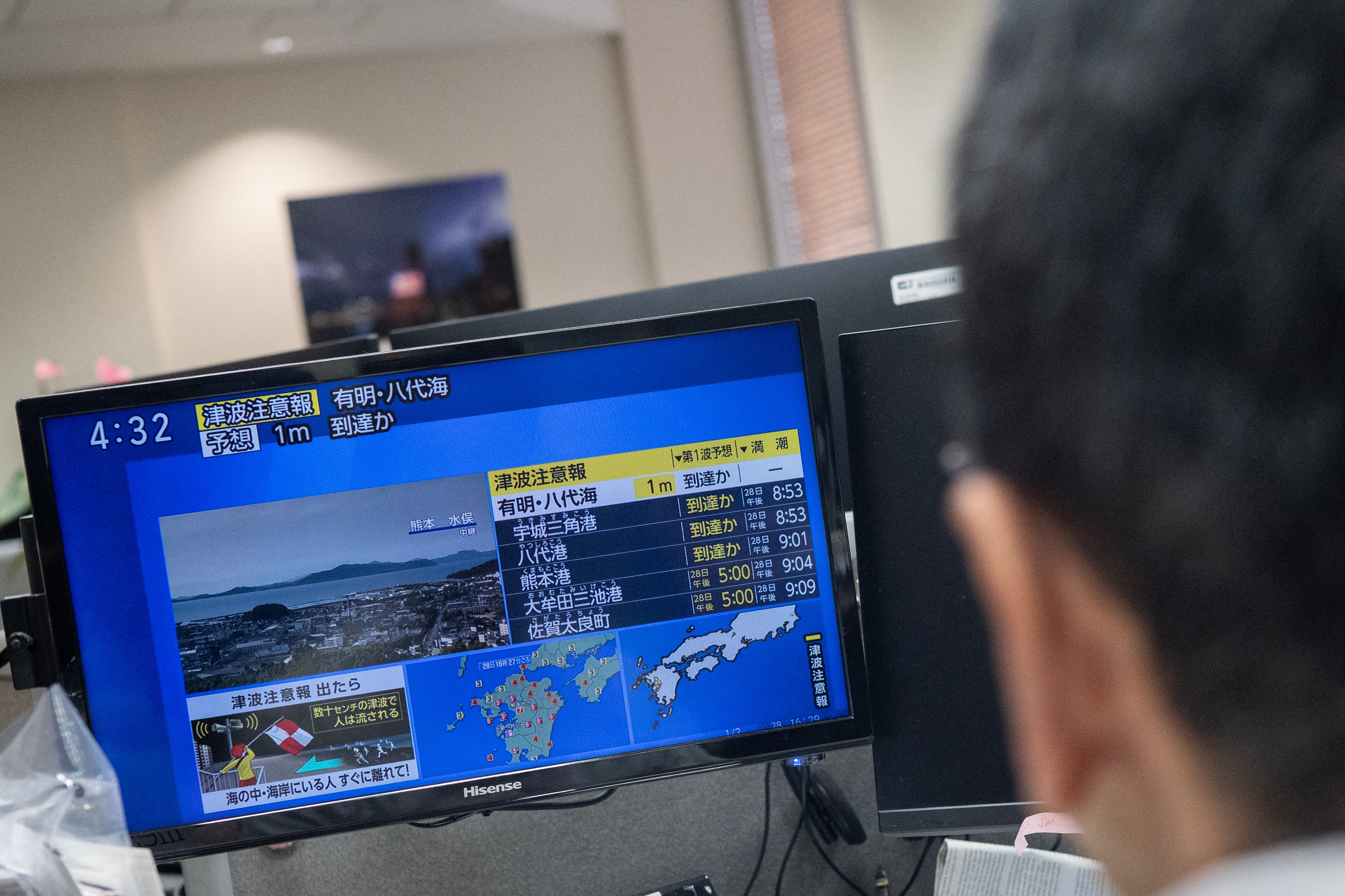 Reporters watch the news showing a large quake and possible one meter tsunami wave in Southern Japan, from an office in Tokyo (AFP/Getty)