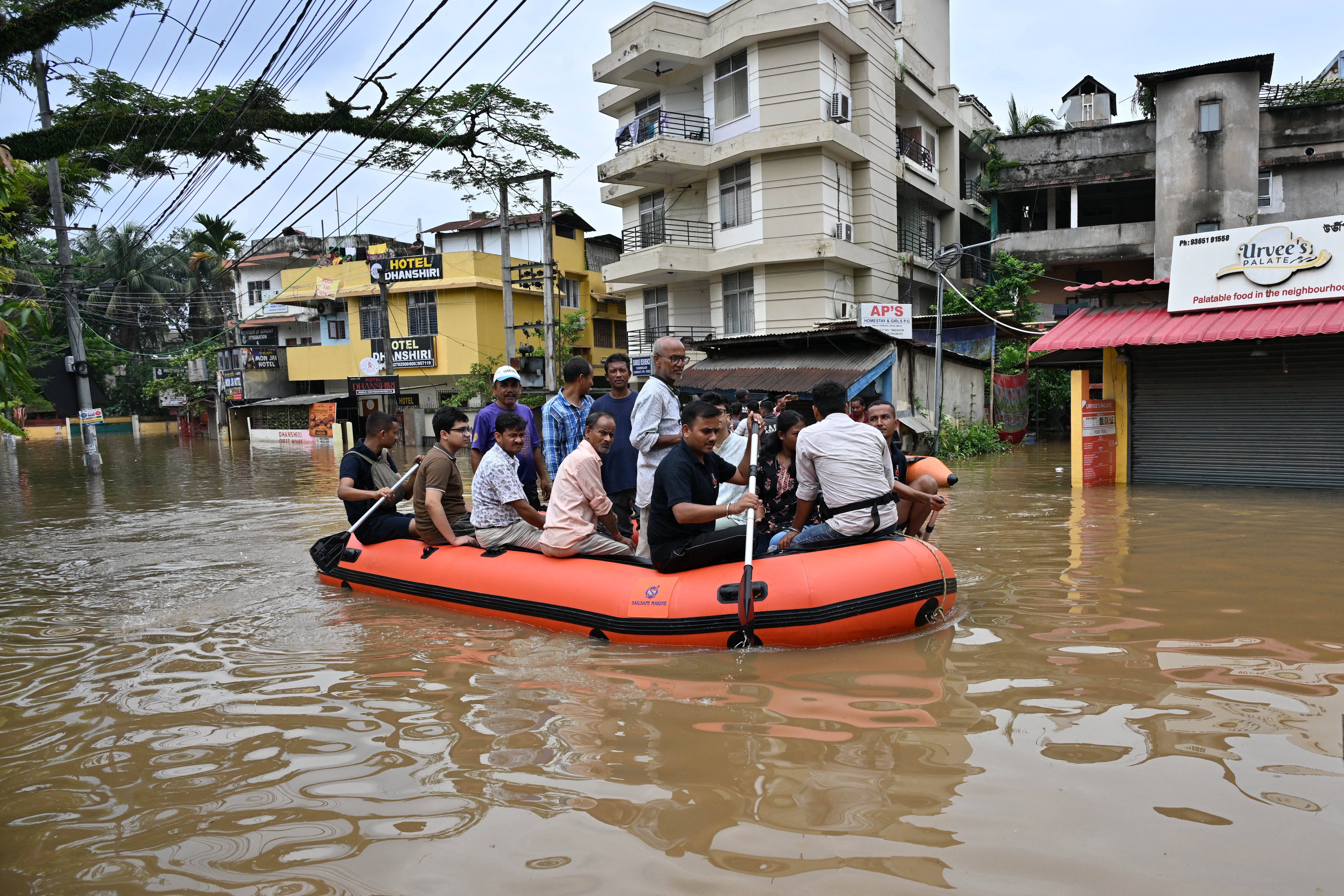 State Disaster Response Fund (SDRF) personnel rescue residents from a flooded area after heavy rainfall in Guwahati (AFP/Getty)