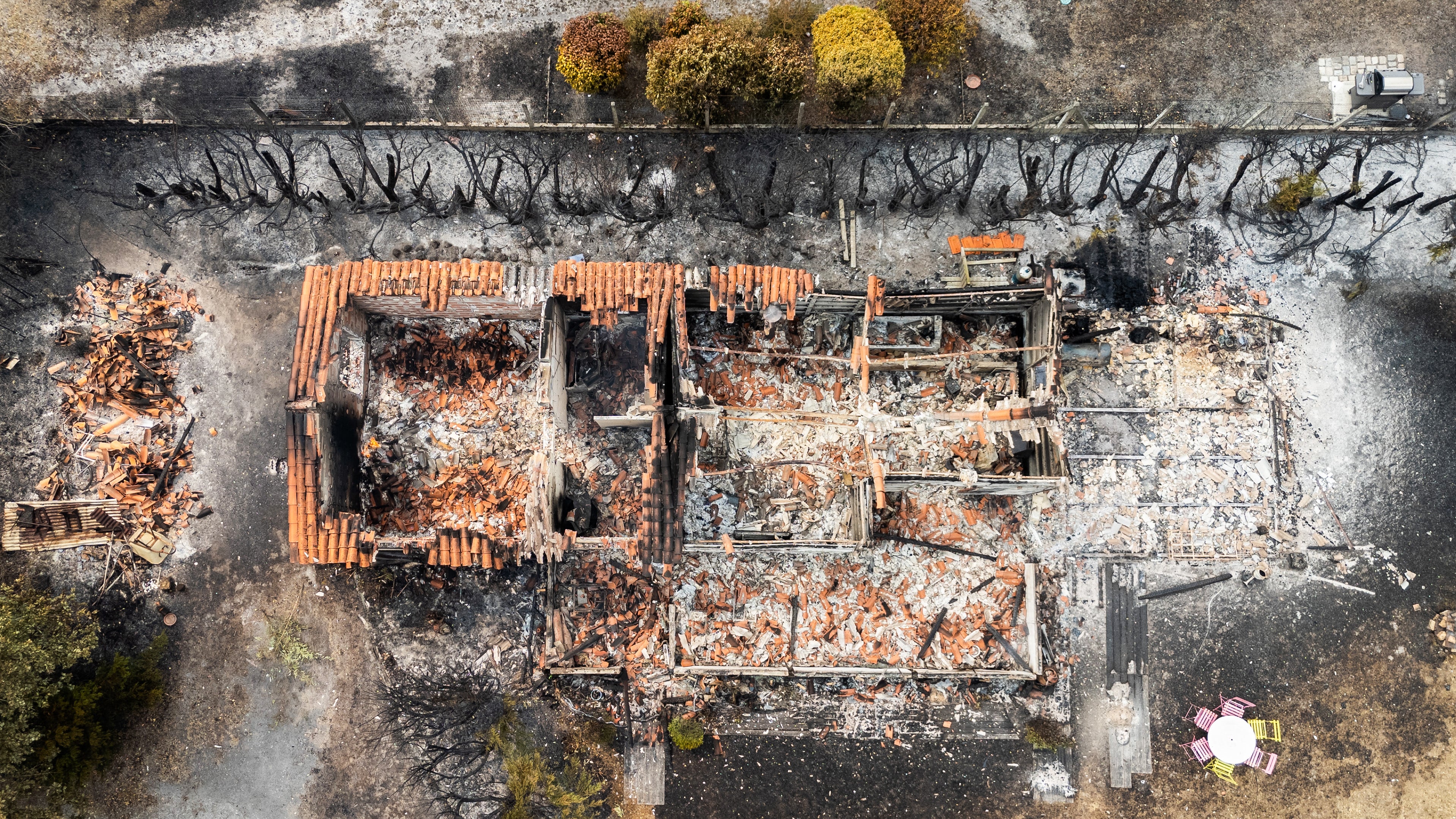 This aerial view shows a burnt building following a wildfire in Le Porge, in the Gironde Department, south-western France on 25 July 2026