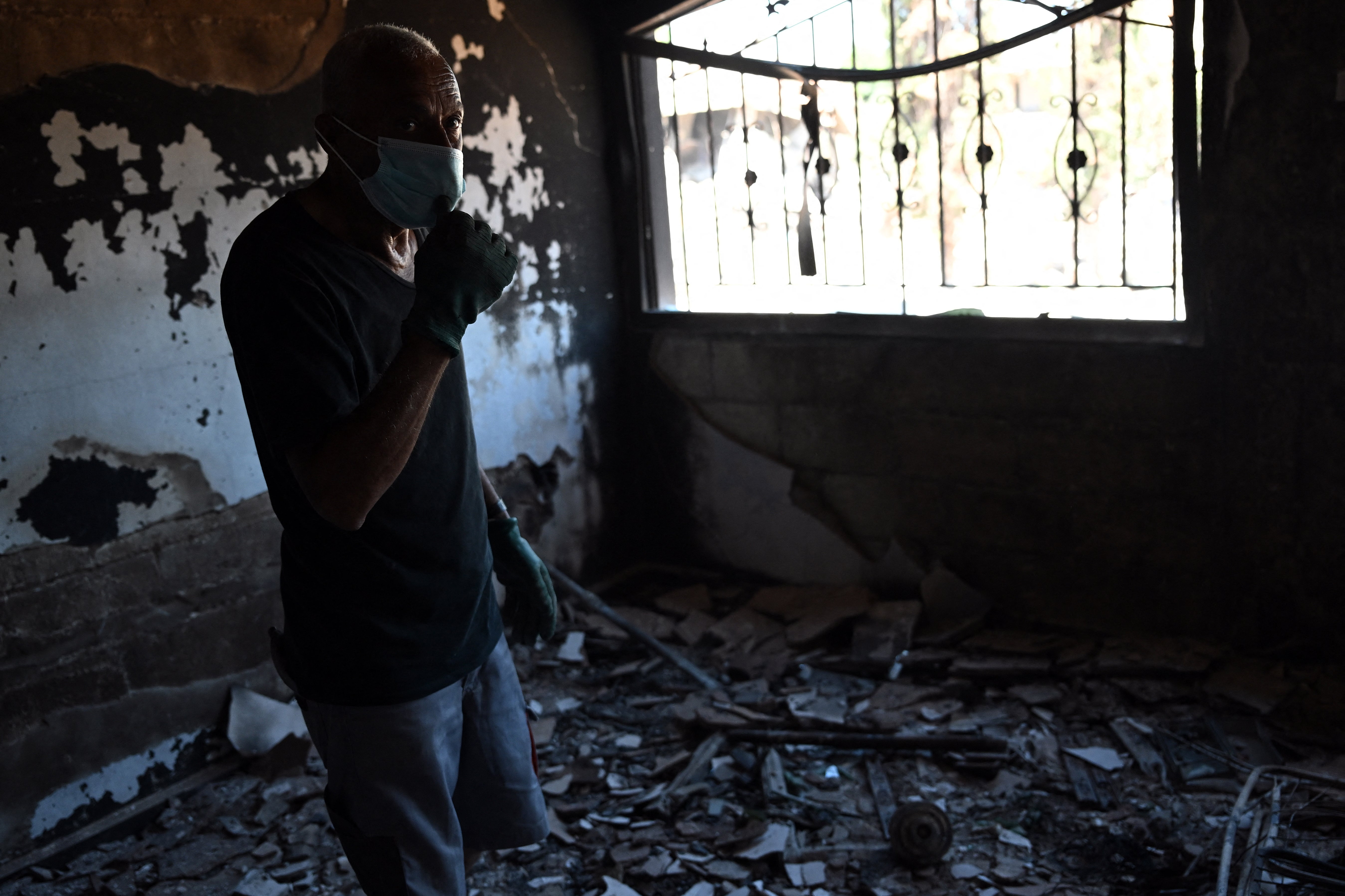 A man inspects his damaged house in Zawtar al-Gharbiya on July 28, 2026, after the Lebanese army deployed to the southern village last week as part of a framework deal reached with Israel.