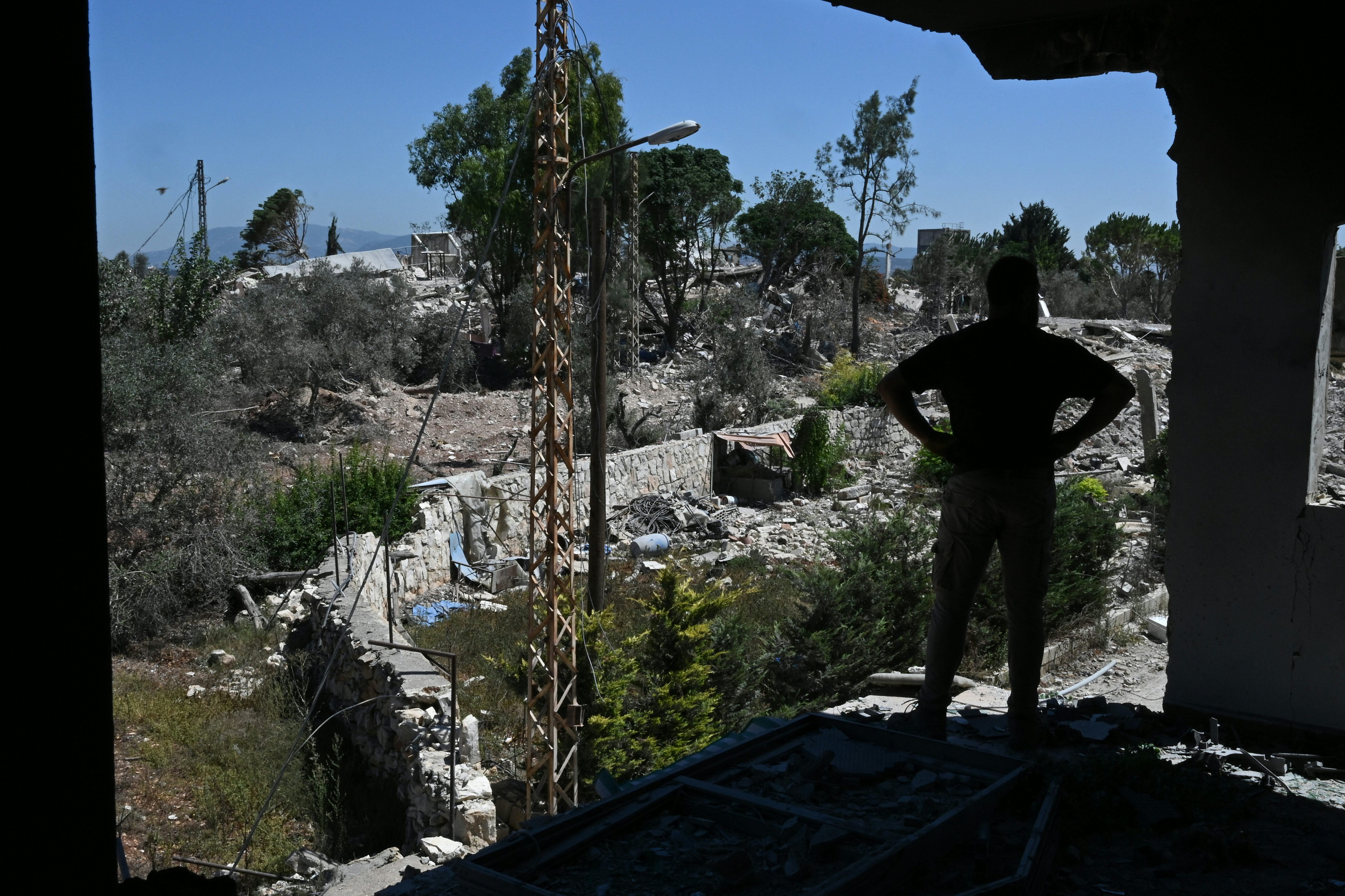 A man looks at the destruction from a damaged house in Zawtar al-Gharbiya on July 28, 2026, as residents check on their homes after the Lebanese army deployed to the southern village last week as part of a framework deal reached with Israel.