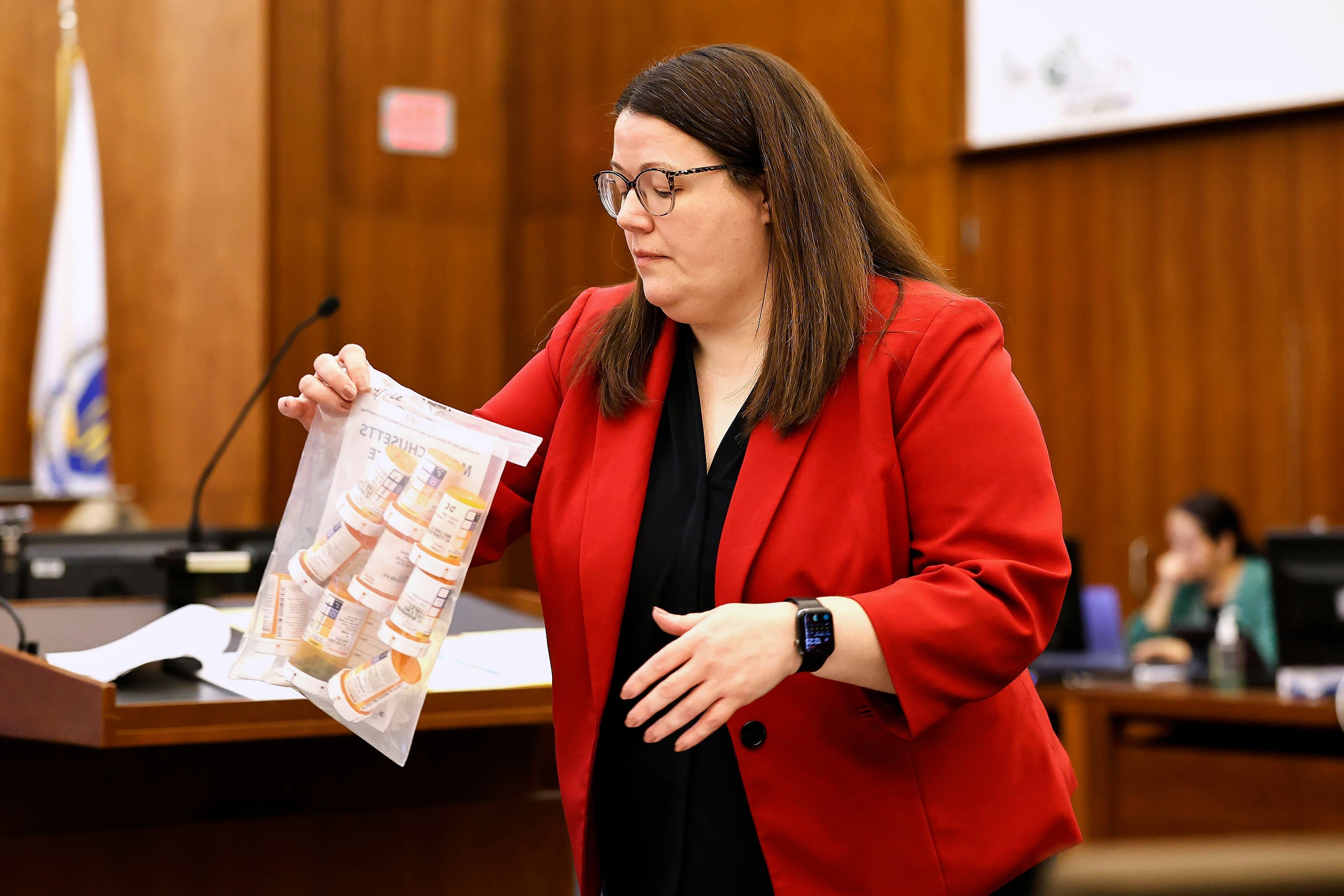 Jennifer Sprague, a prosecutor with the Plymouth County District Attorney's Office, enters a bag of prescription pills as evidence in Lindsay Clancy's trial (Greg Derr/Pool The Patriot Ledge)