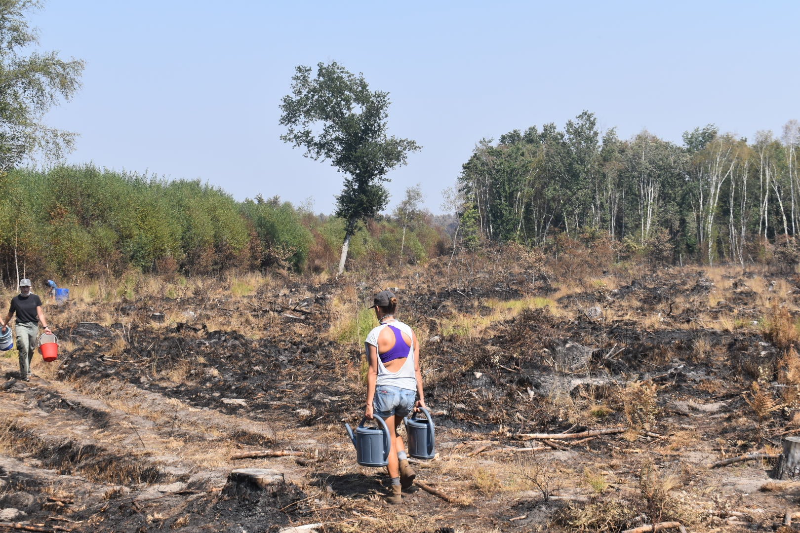 Lacanau residents carried buckets of water into the devastated landscape to help put out fires themselves