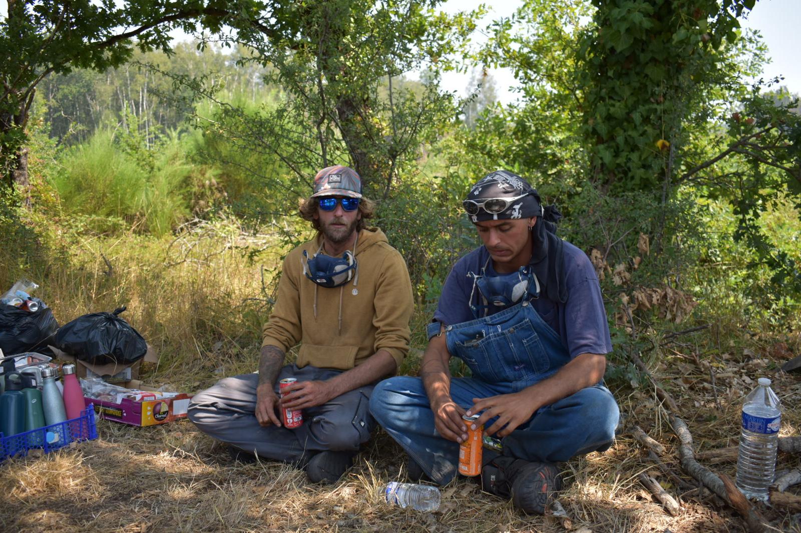 Volunteers rest between patrols of the burned out countryside