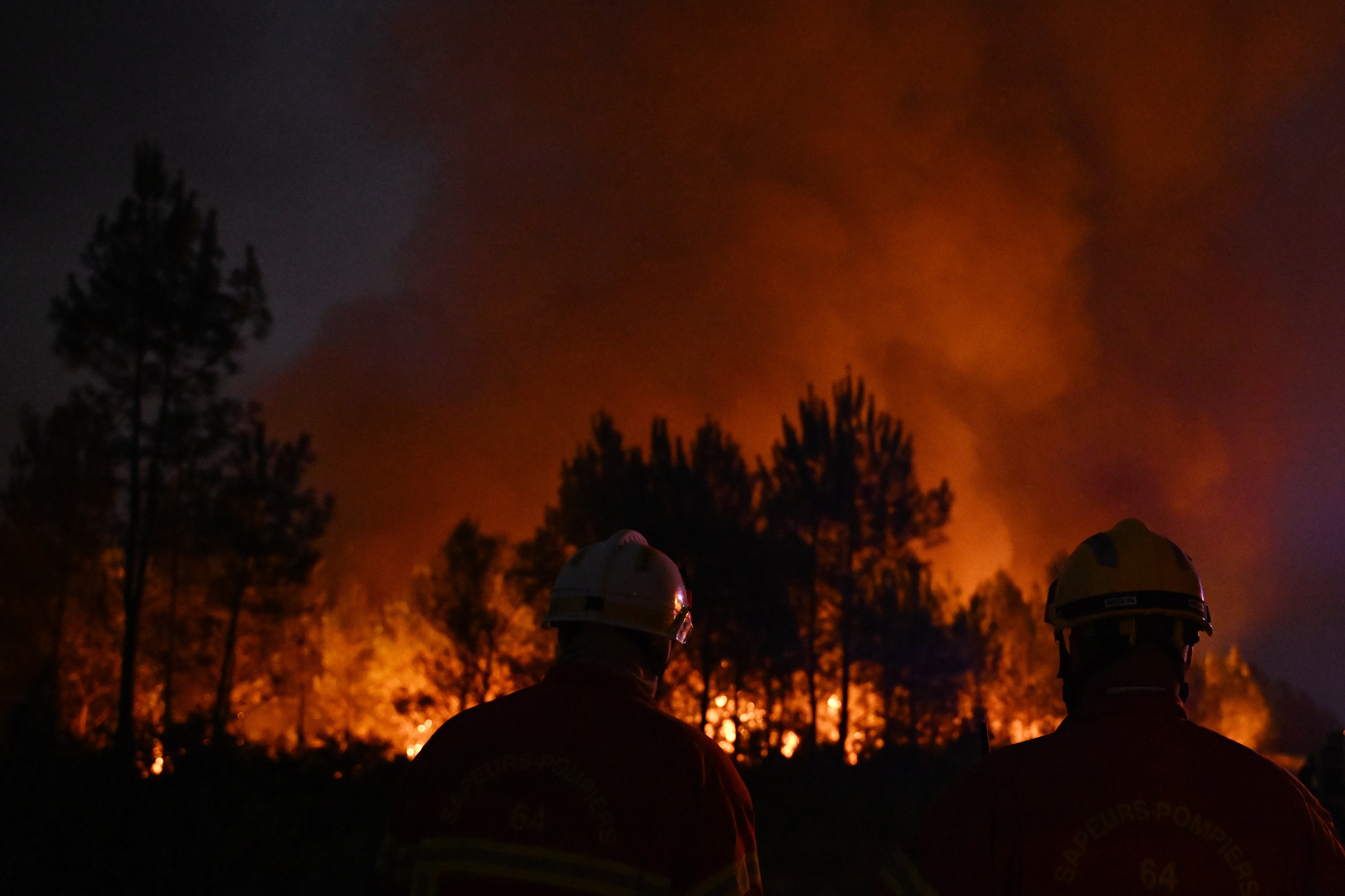 Firefighters battle a blaze outside Lanton, around 30 miles south of Lacanau