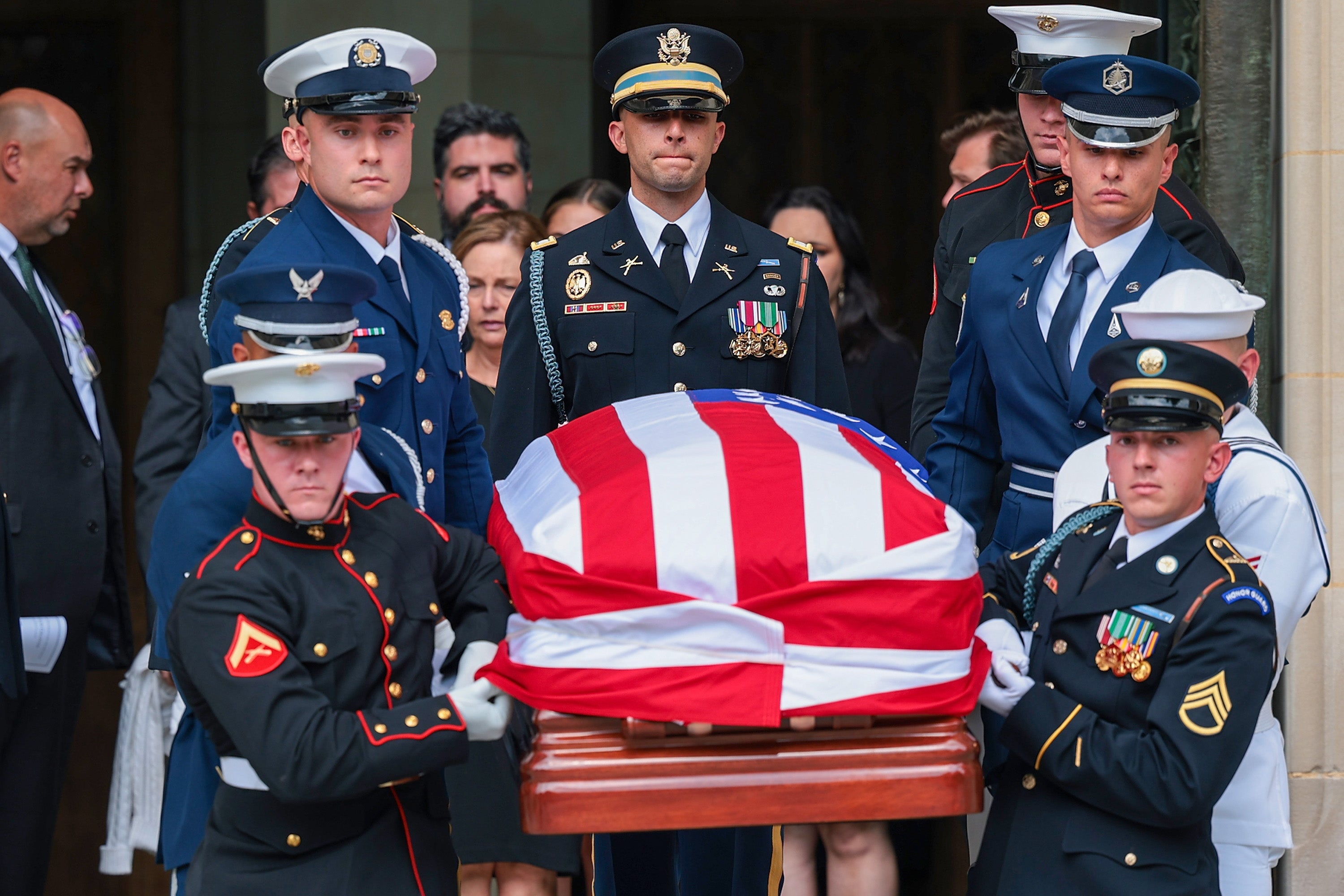 A military body bearer team carries Lindsey Graham’s casket out at the conclusion of the National cathedral after his funeral service Tuesday.