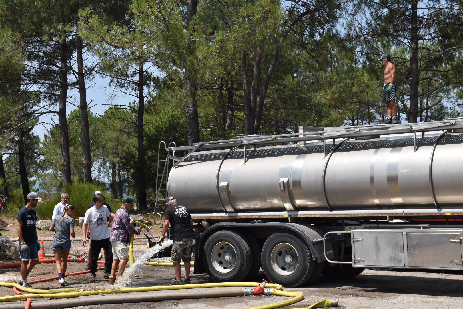 At the port, residents collect water to use in firefighting efforts in the forest