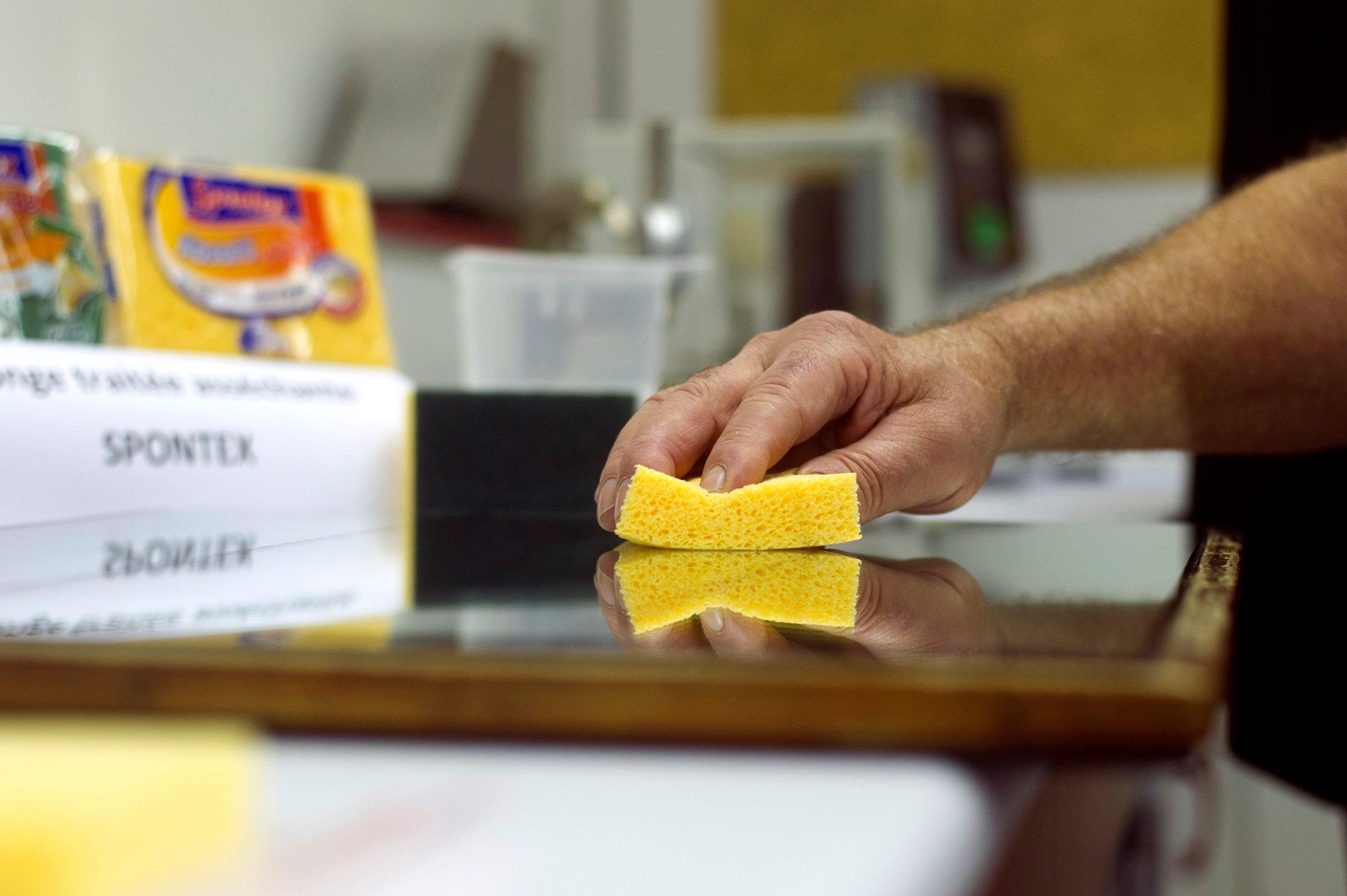 An employee makes tests on a sponge (AFP via Getty Images)