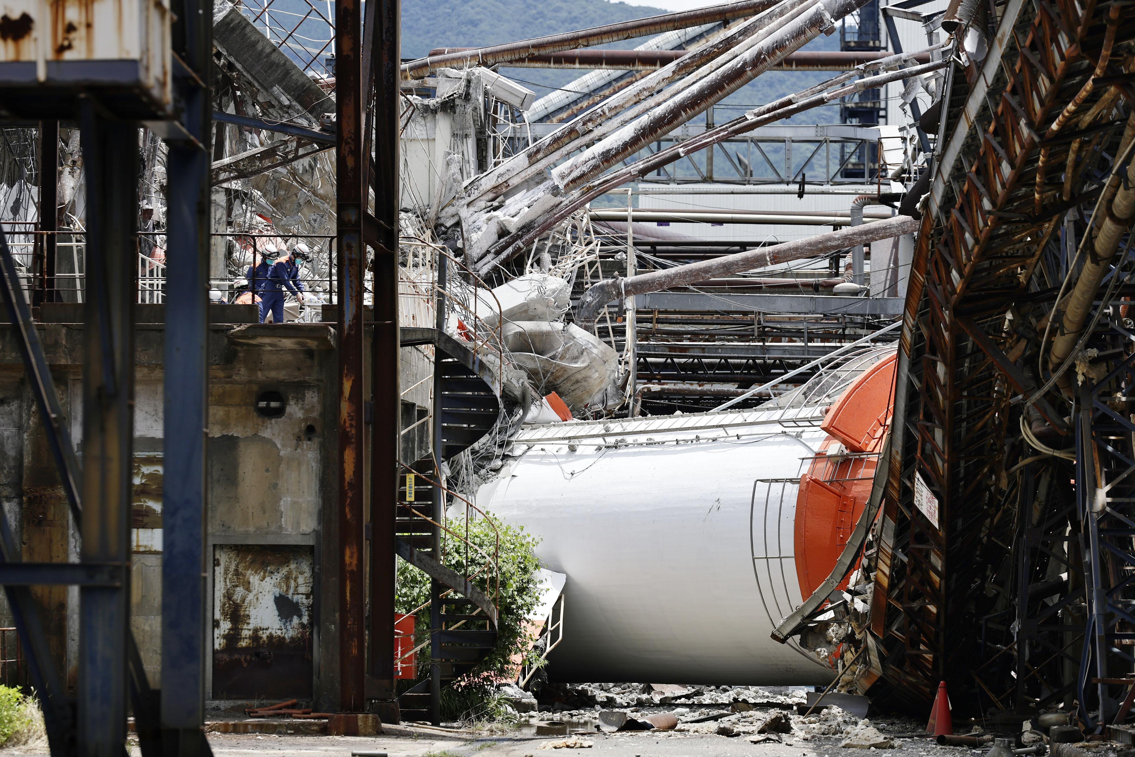 A collapsed chimney of the Nippon Paper Industries Co.’s Yatsushiro factory, is partly seen following an earthquake in Yatsushiro, Kumamoto Prefecture, Wednesday