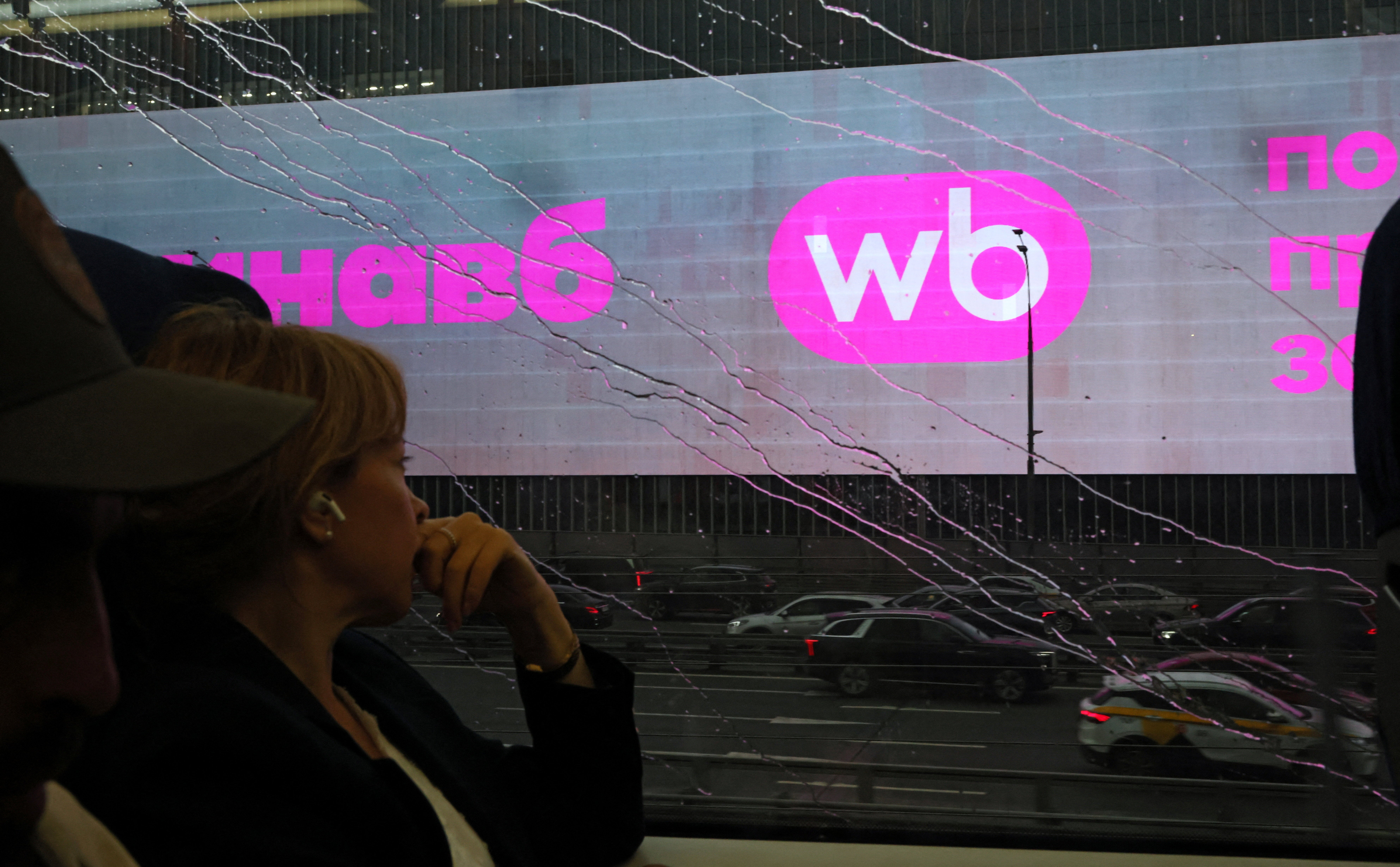 A woman rides a train past a screen advertising the Wildberries online retailer in Moscow, Russia 28 July 2026