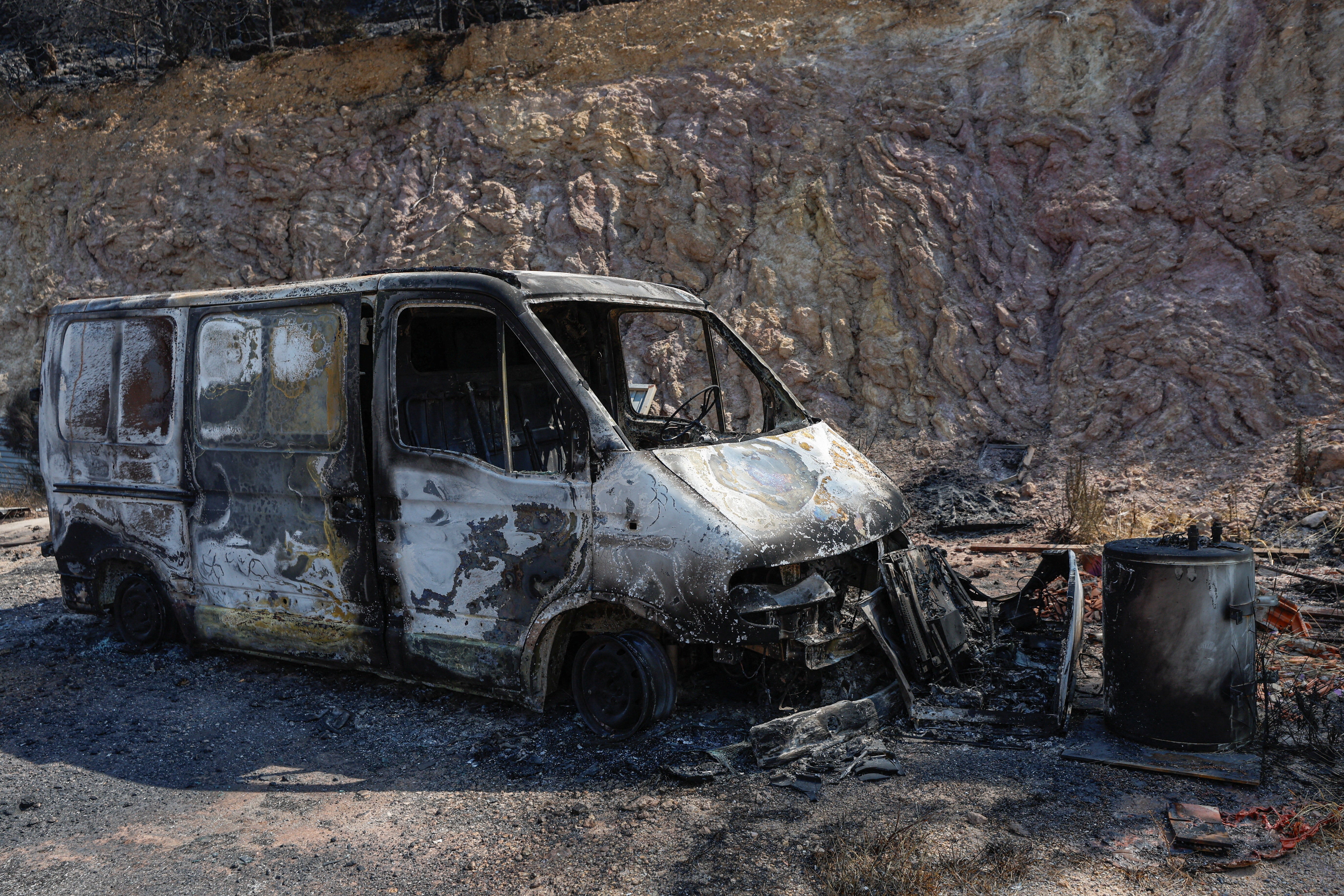 A burned-out car stands in an area affected by a wildfire in La Vall d'Uixo, Castellon province, Spain, July 28 (Reuters)
