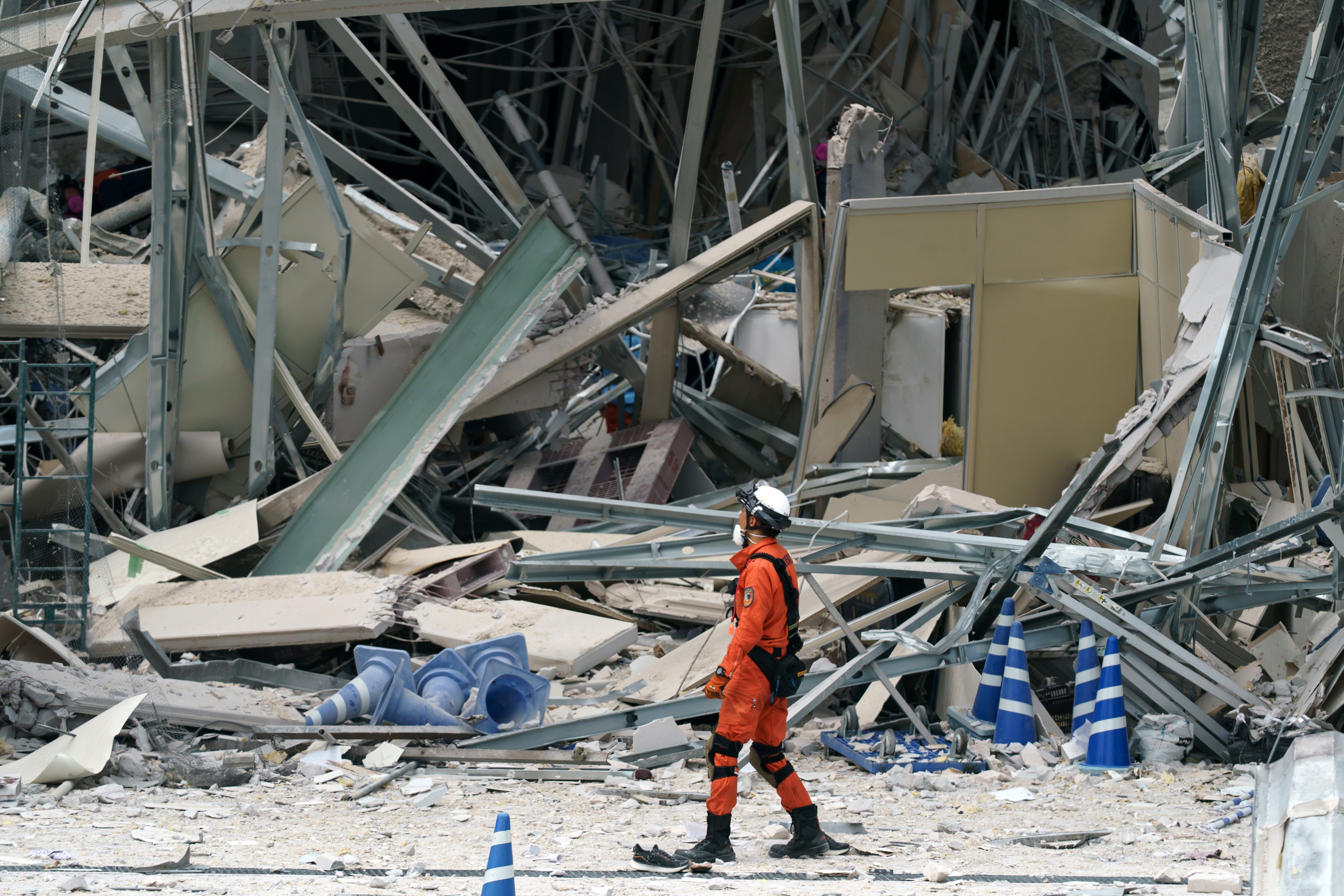 A firefighter searches for missing people at Aeon Mall Kumamoto which was damaged by an explosion following an earthquake on July 29, 2026 in Kashima, Kumamoto Prefecture (Getty)