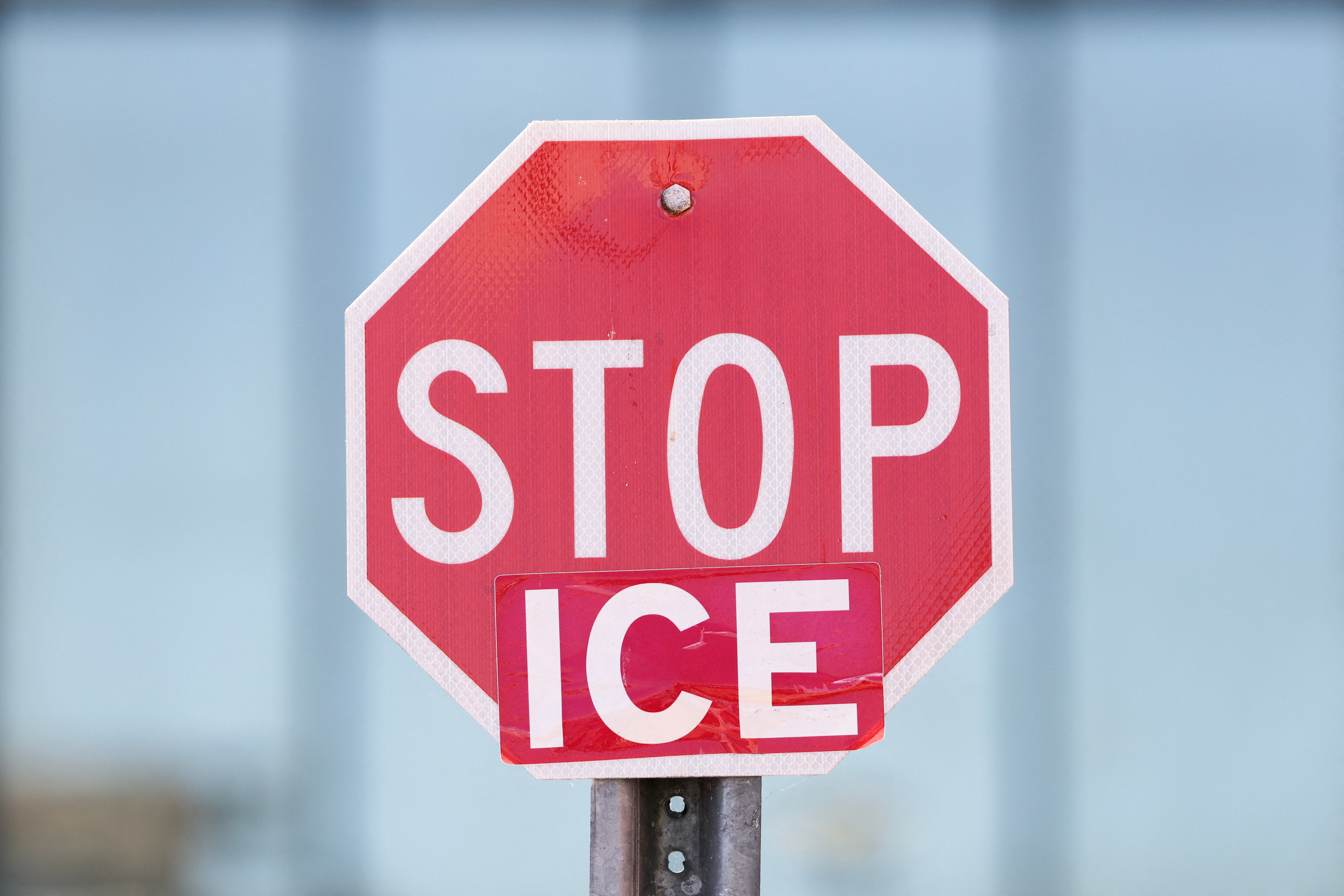A "Stop ICE" sign is displayed outside of a Home Depot store on Wilshire Boulevard