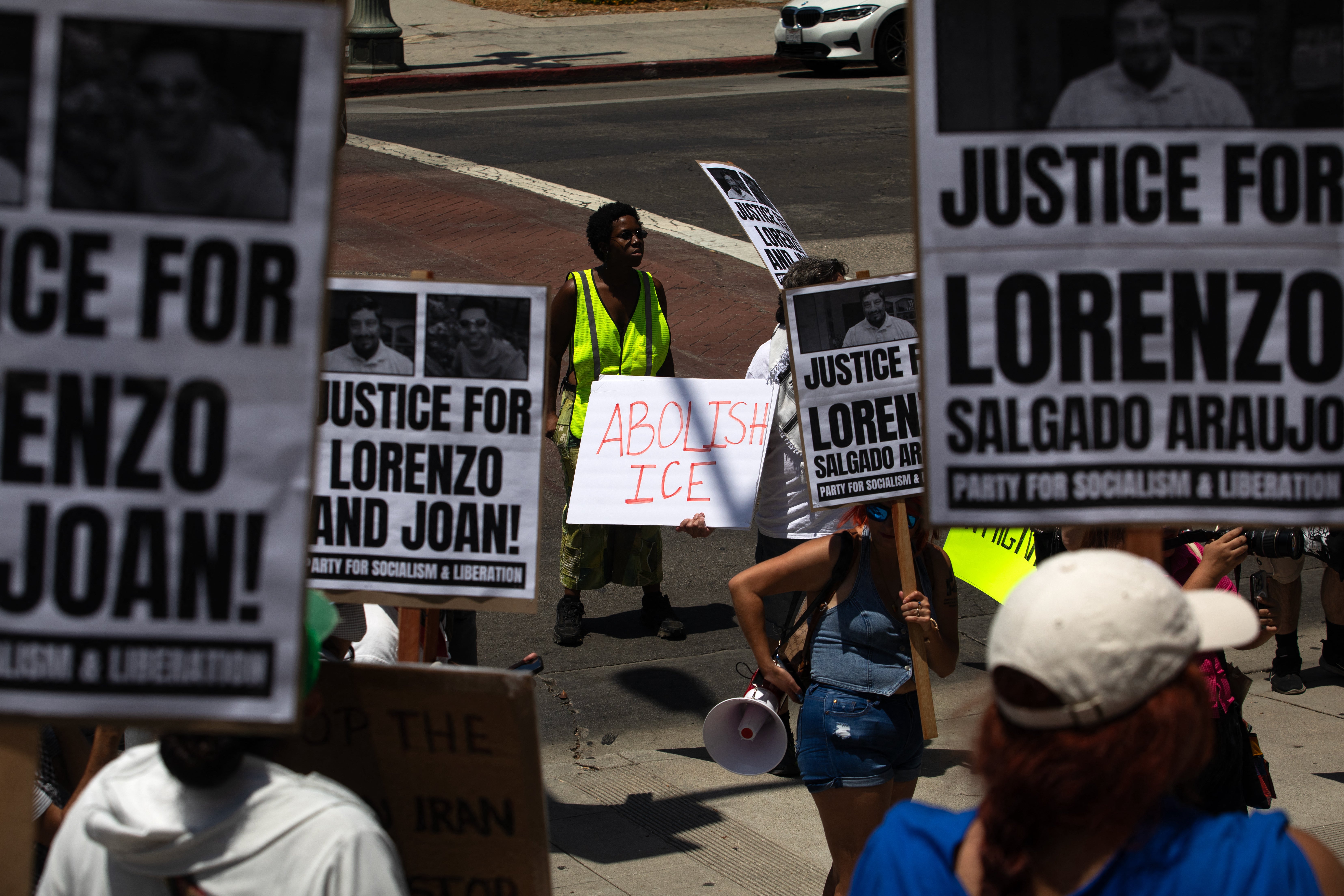 A protester holds a sign that reads "Abolish ICE" during a National Day of Action protest against US Immigration and Customs Enforcement (ICE) in downtown Los Angeles, California on July 18, 2026