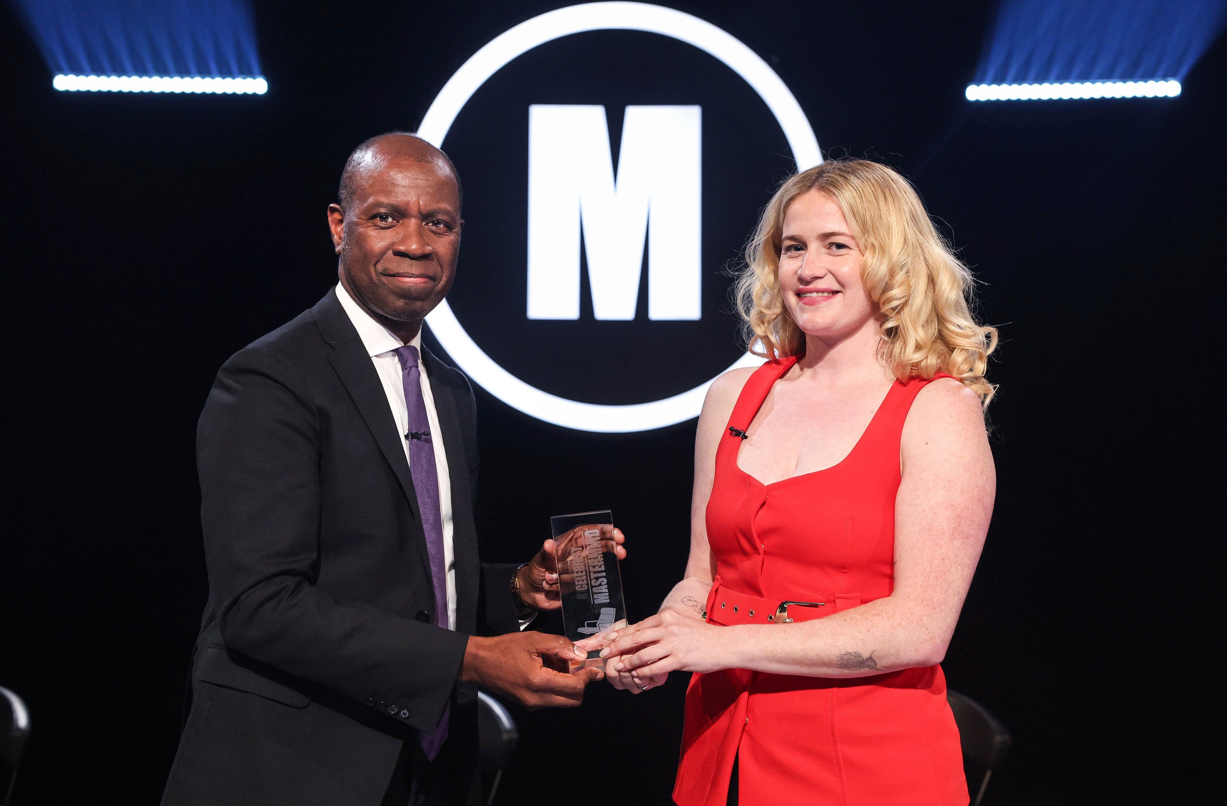 Clive Myrie presents comedian Grace Campbell with her winning trophy in the most recent series of 'Celebrity Mastermind'