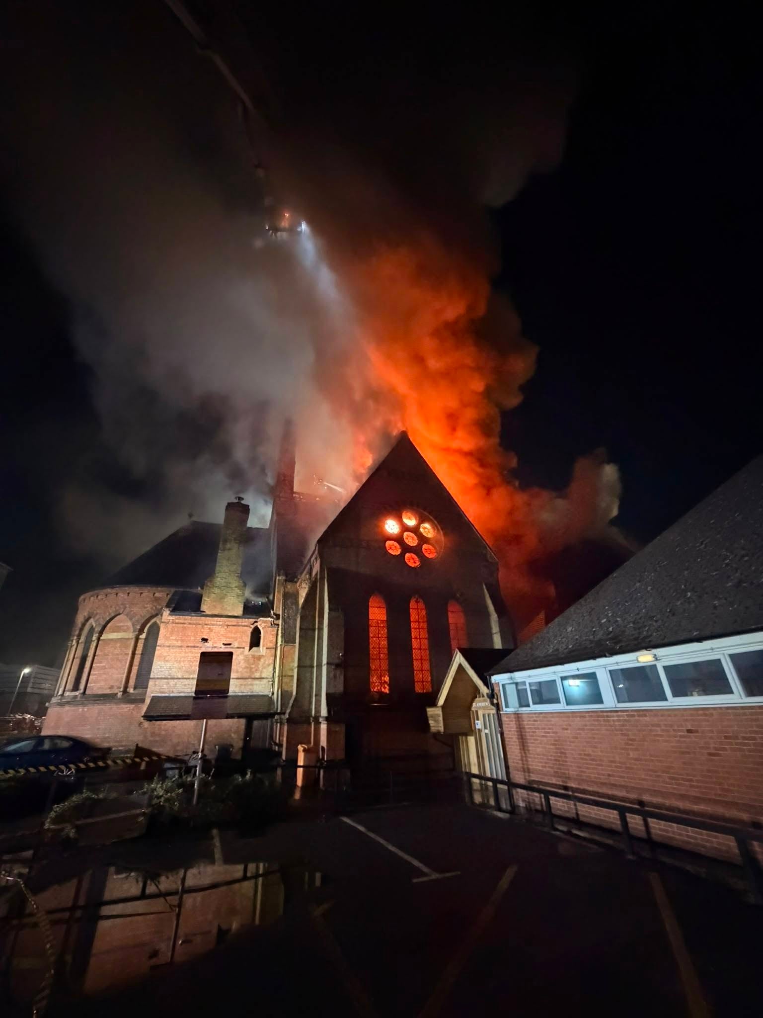Firefighters rush into burning church to rescue coffin from devastating fire