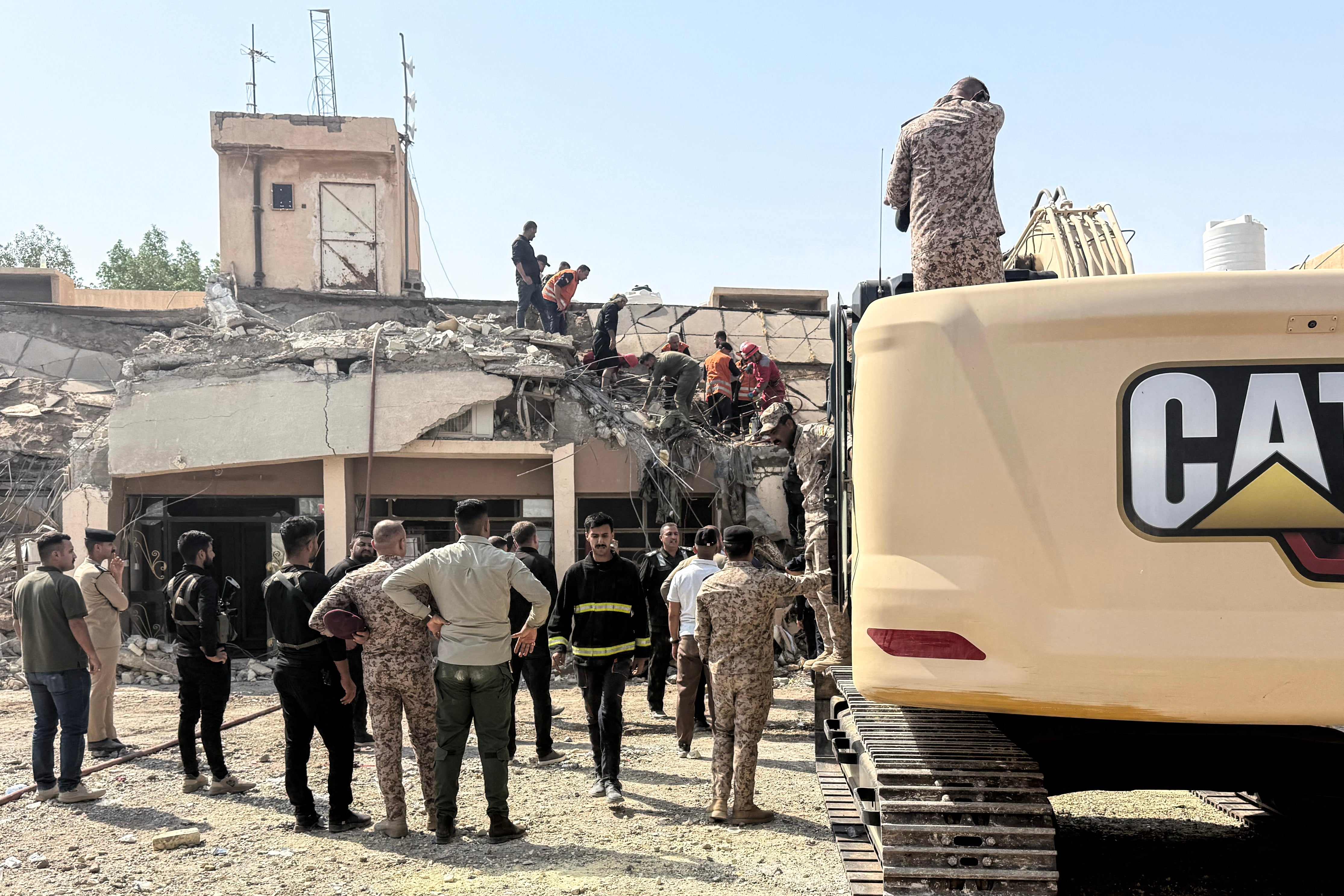 Security forces and emergency personnel work at the site of a strike north of al-Miqdadiyah district in Iraq's Dayala province on July 29 (AFP/Getty)