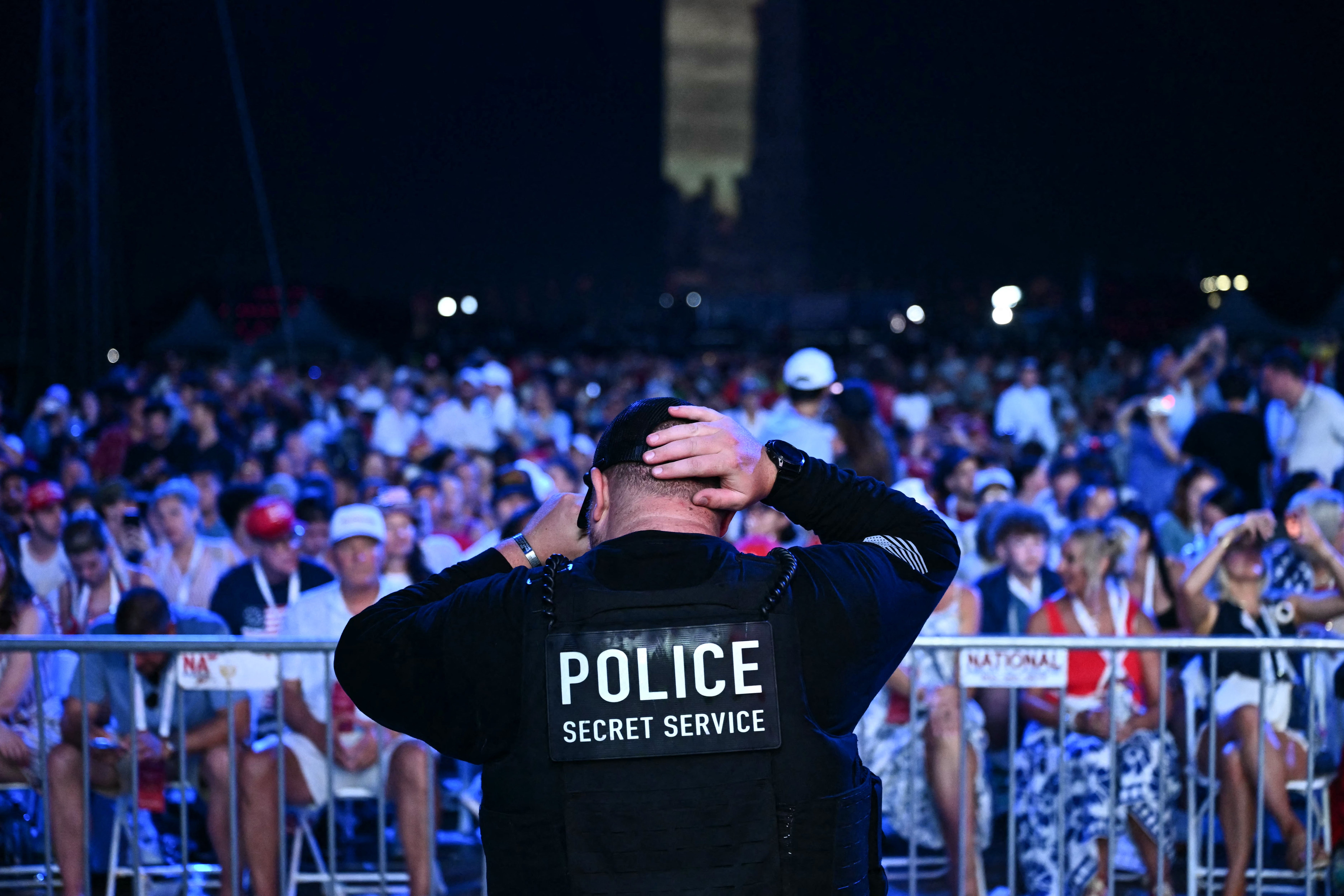 A member of the US Secret Service stands as audience members wait for US President Donald Trump to speak during the "Salute to America" Independence Day celebration on the National Mall in Washington, DC, on July 4