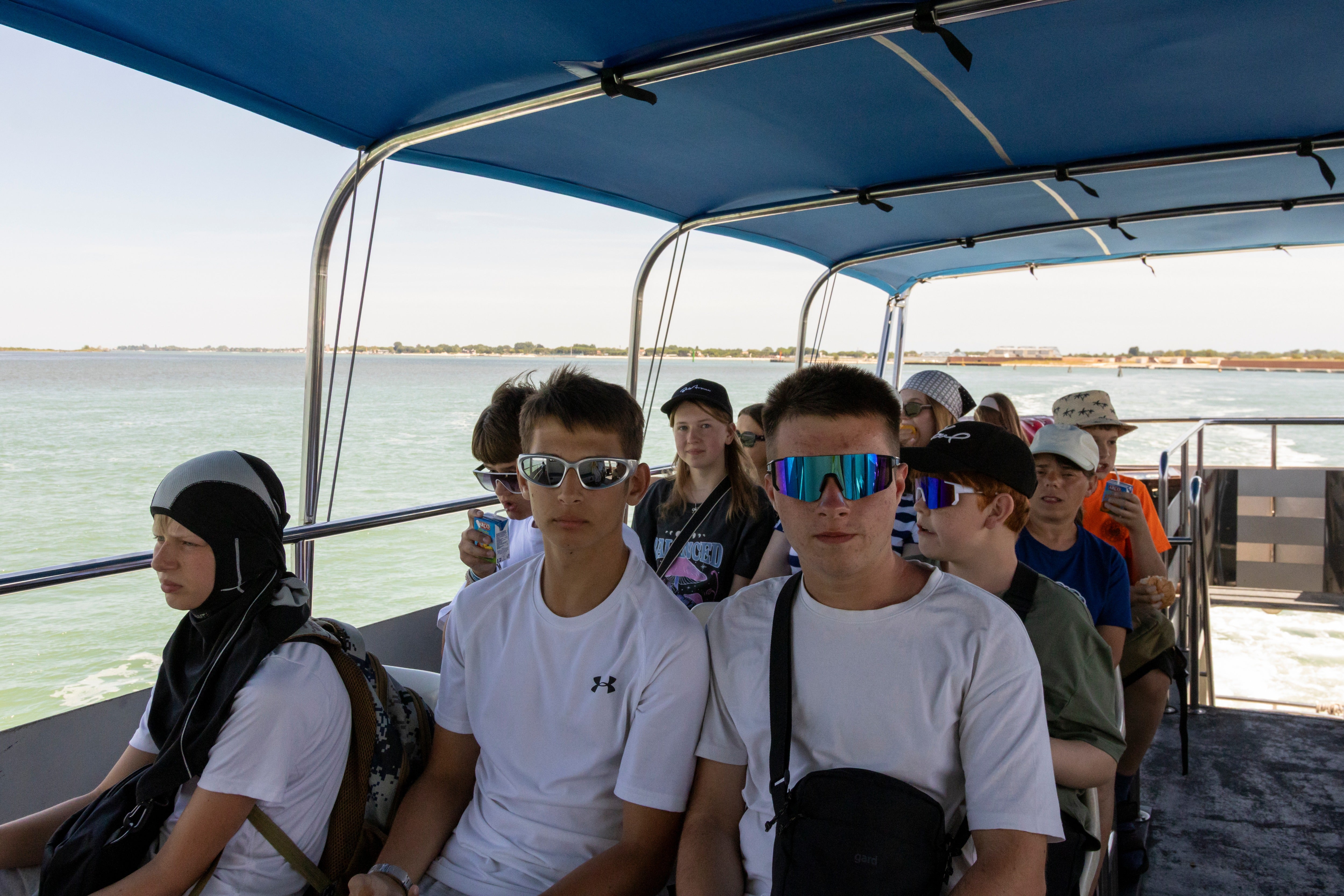 Yevhen, middle, and Vlad, right, on a boat during their holiday to Italy