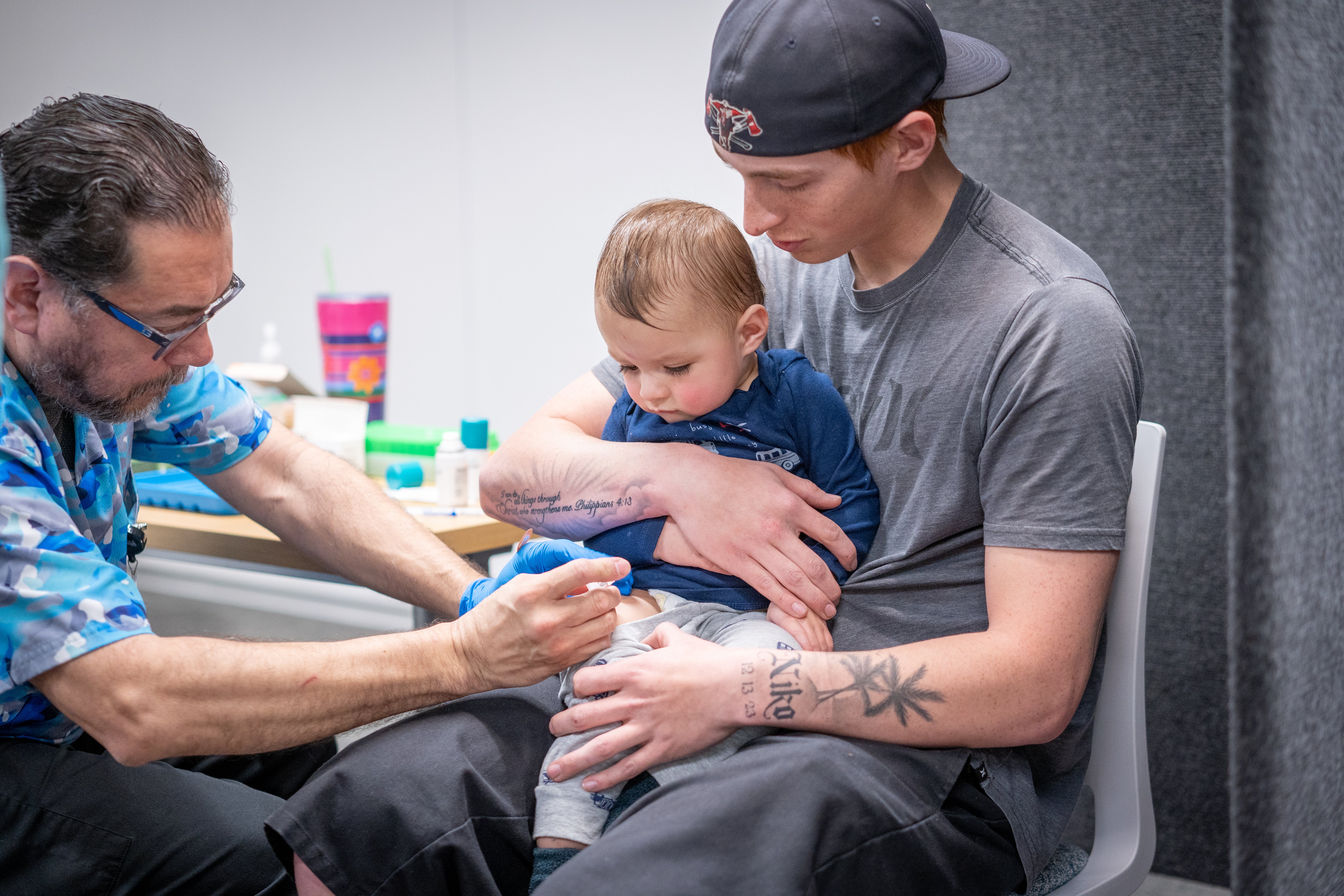 Ethan Turner holds his 14-month-old son, Niko, while he gets the measles vaccine at a clinic in Lubbock, Texas, in March 2025. Increased vaccination helped to end the measles outbreak in Texas last August (Getty)