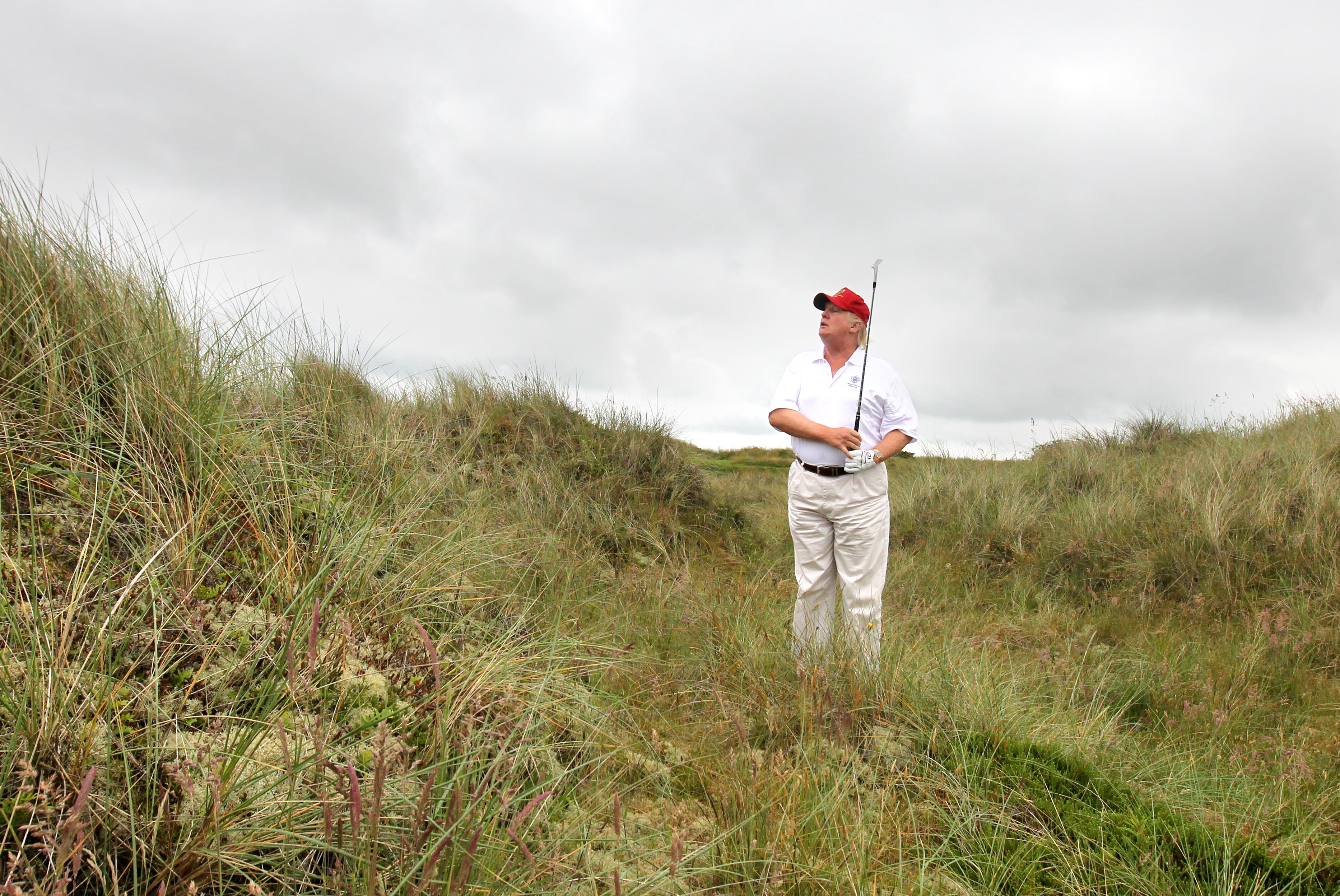 Donald Trump plays from the rough on a visit to his golf course near Aberdeen (PA)