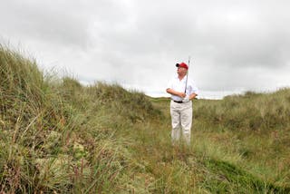 Donald Trump plays from the rough on a visit to his golf course near Aberdeen (PA)