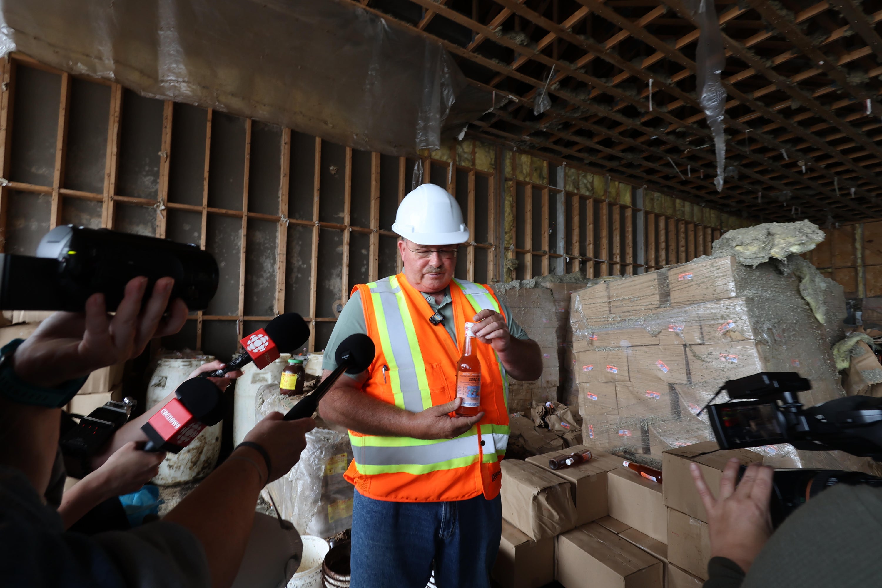 Glenn Sharp, owner of Sharp Management, is shown holding a bottle of fish sauce in the abandoned plant