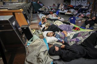 People take shelter inside a metro station during a Russian missile and drone attack in Kyiv