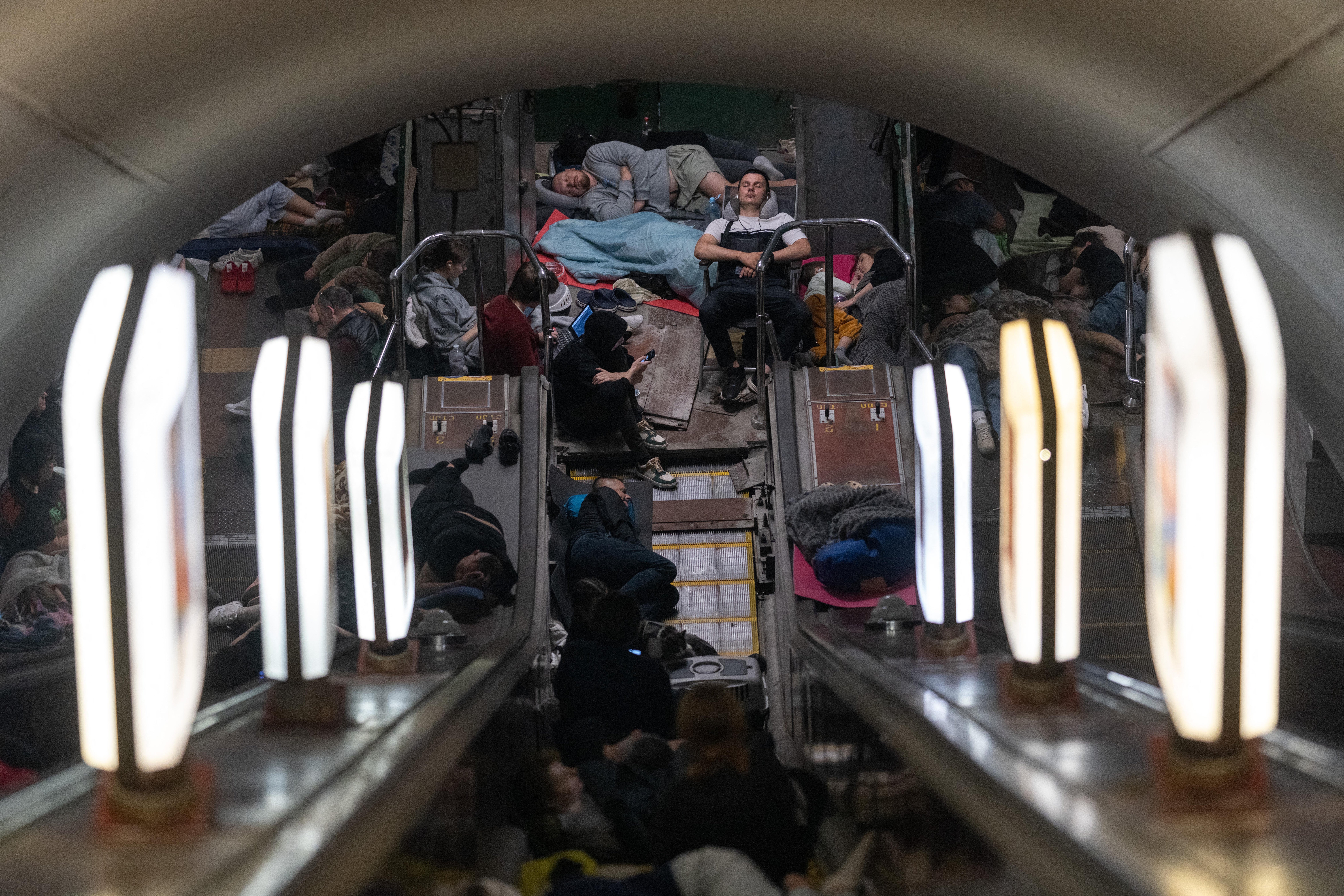People take shelter at a metro station during Russian missile strike on Kyiv