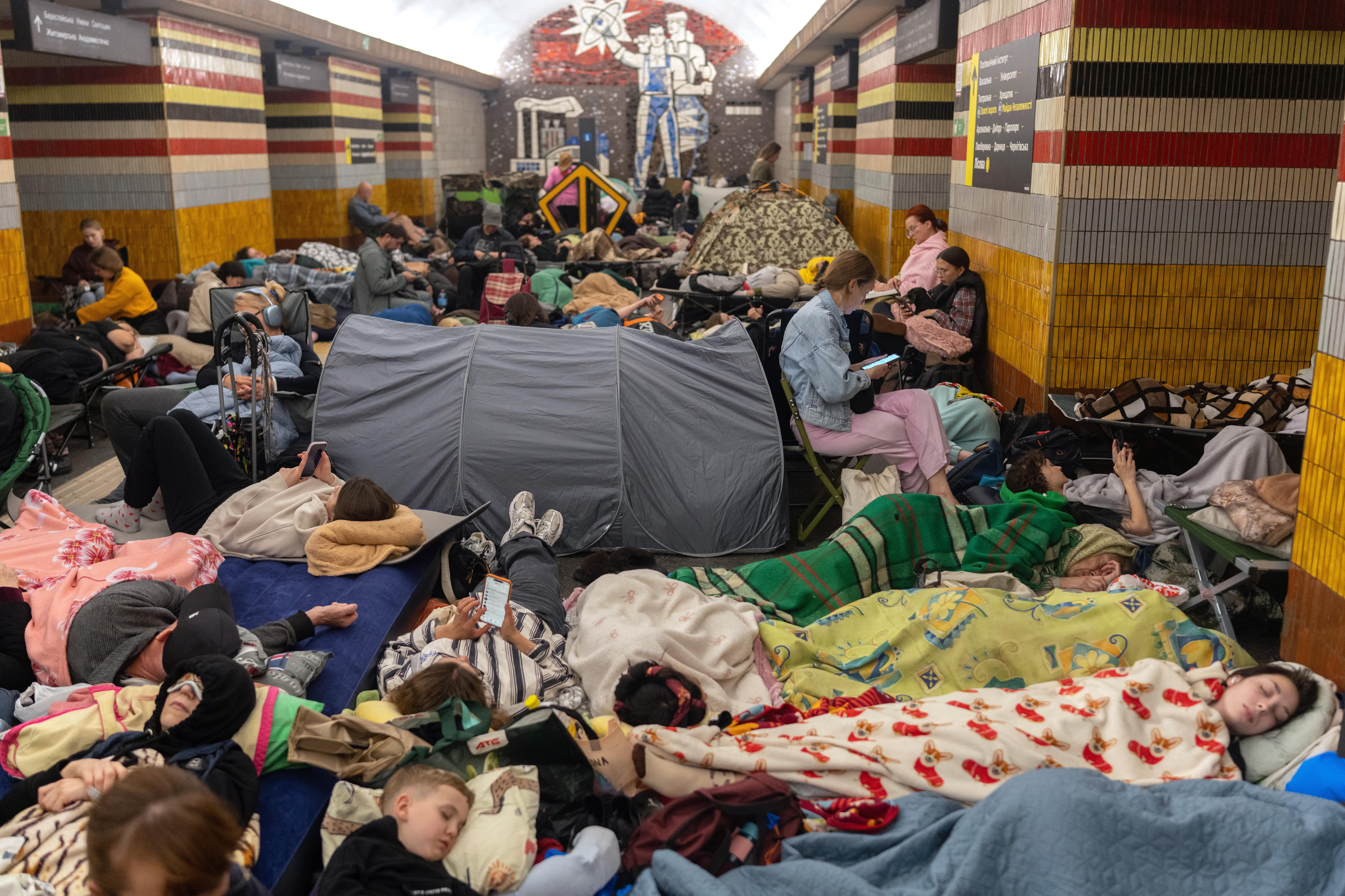 People take shelter at a metro station during Russian missile strike on Kyiv,