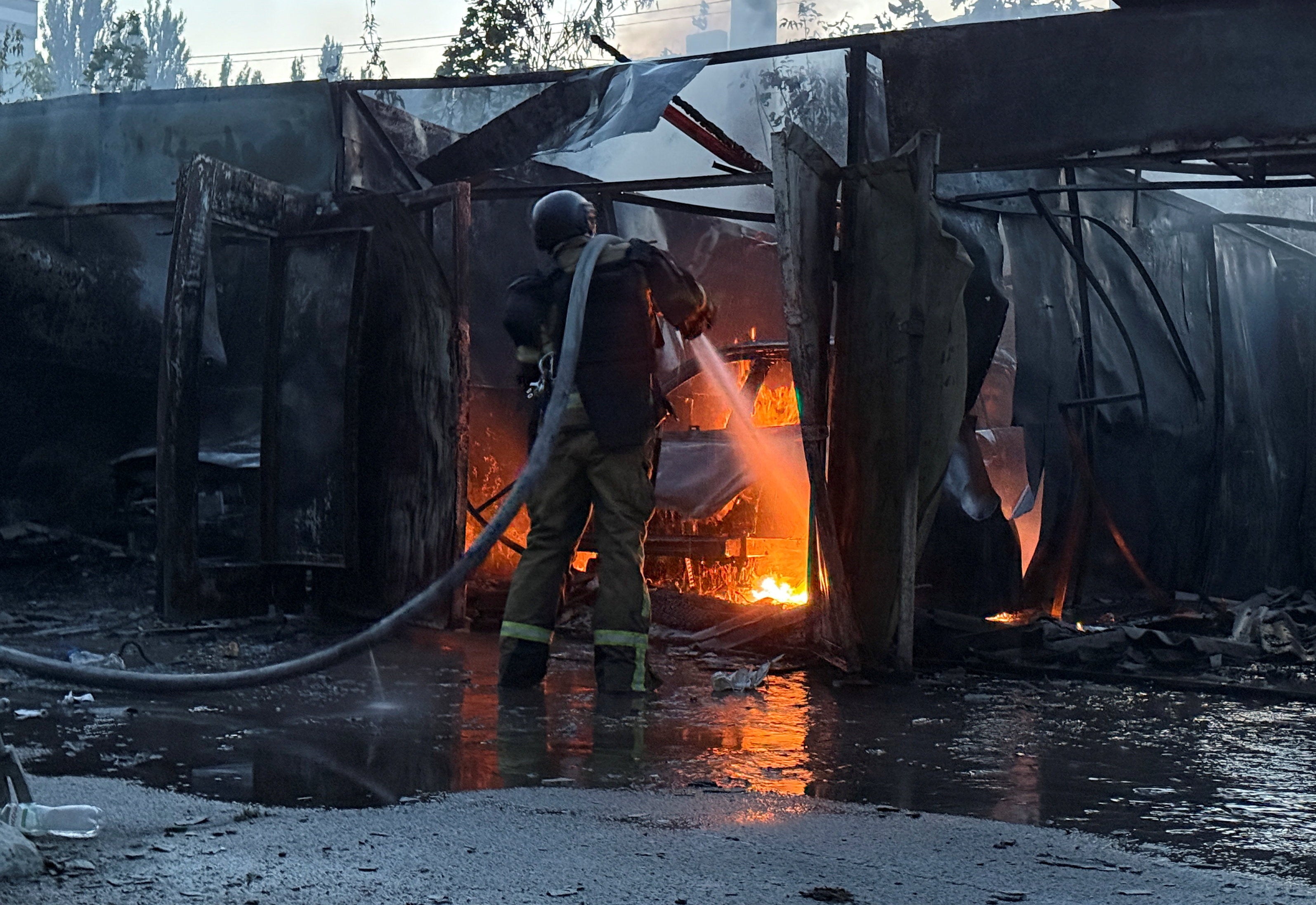 A firefighter works at the site of a Russian missile strike