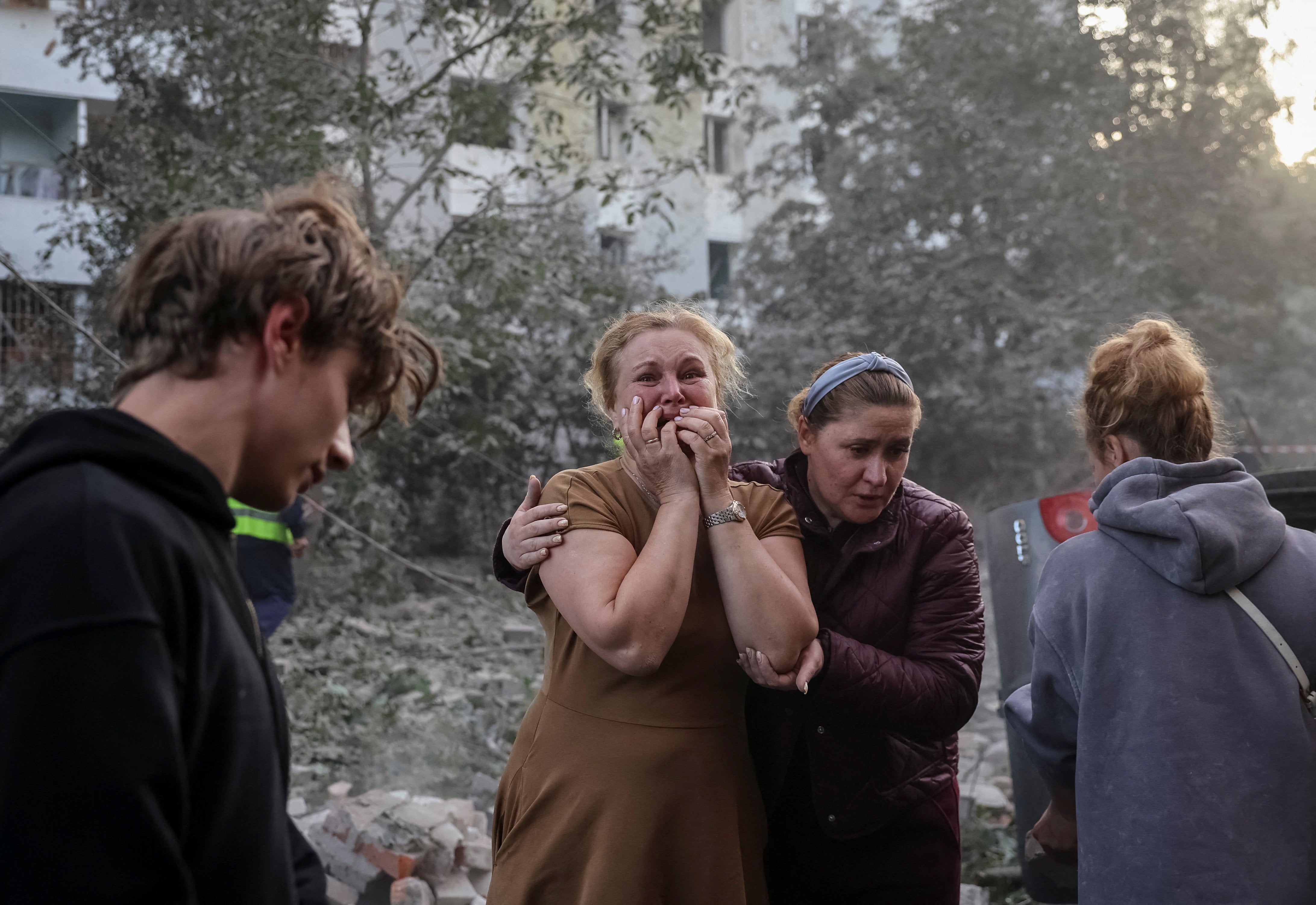 A woman reacts near an apartment building hit by a Russian missile strike, amid Russia's attack on Ukraine, in Lviv, Ukraine