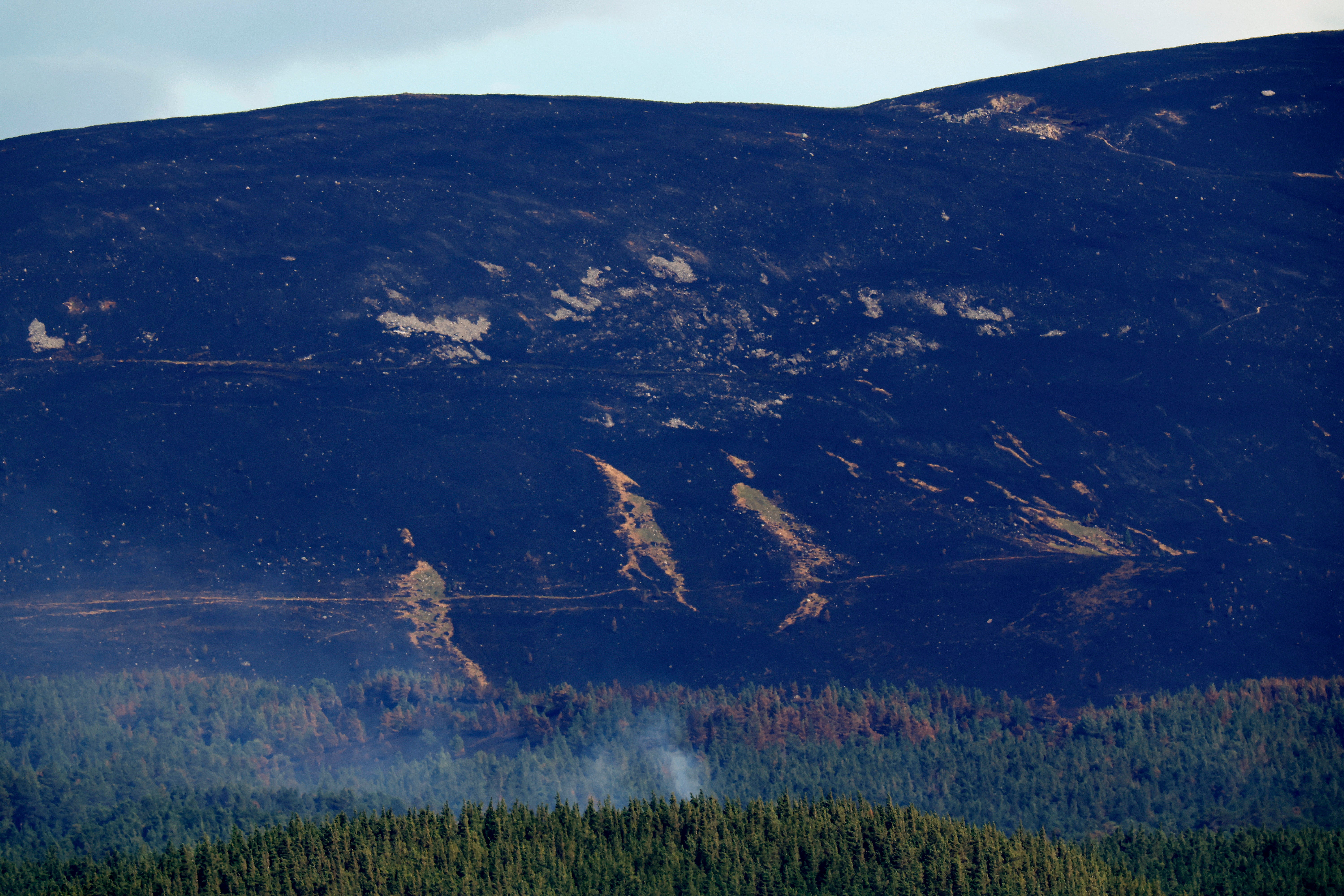 Firefighters are still working to contain a bushfire in the Cairngorms that broke out two weeks ago.
