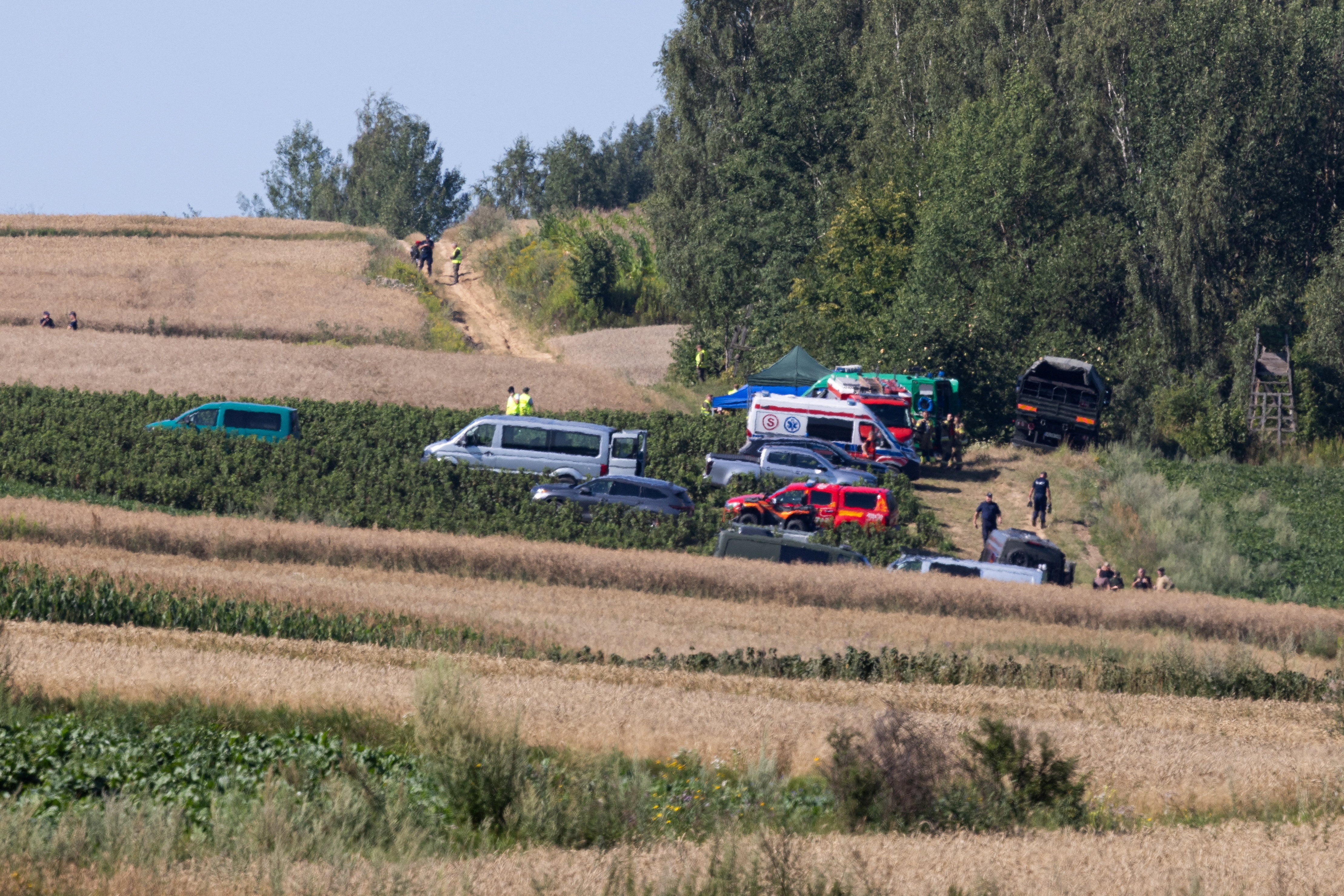 Emergency services work at the site where an unidentified flying object, believed to be a Russian cruise missile, fell after violating Polish airspace on Thursday