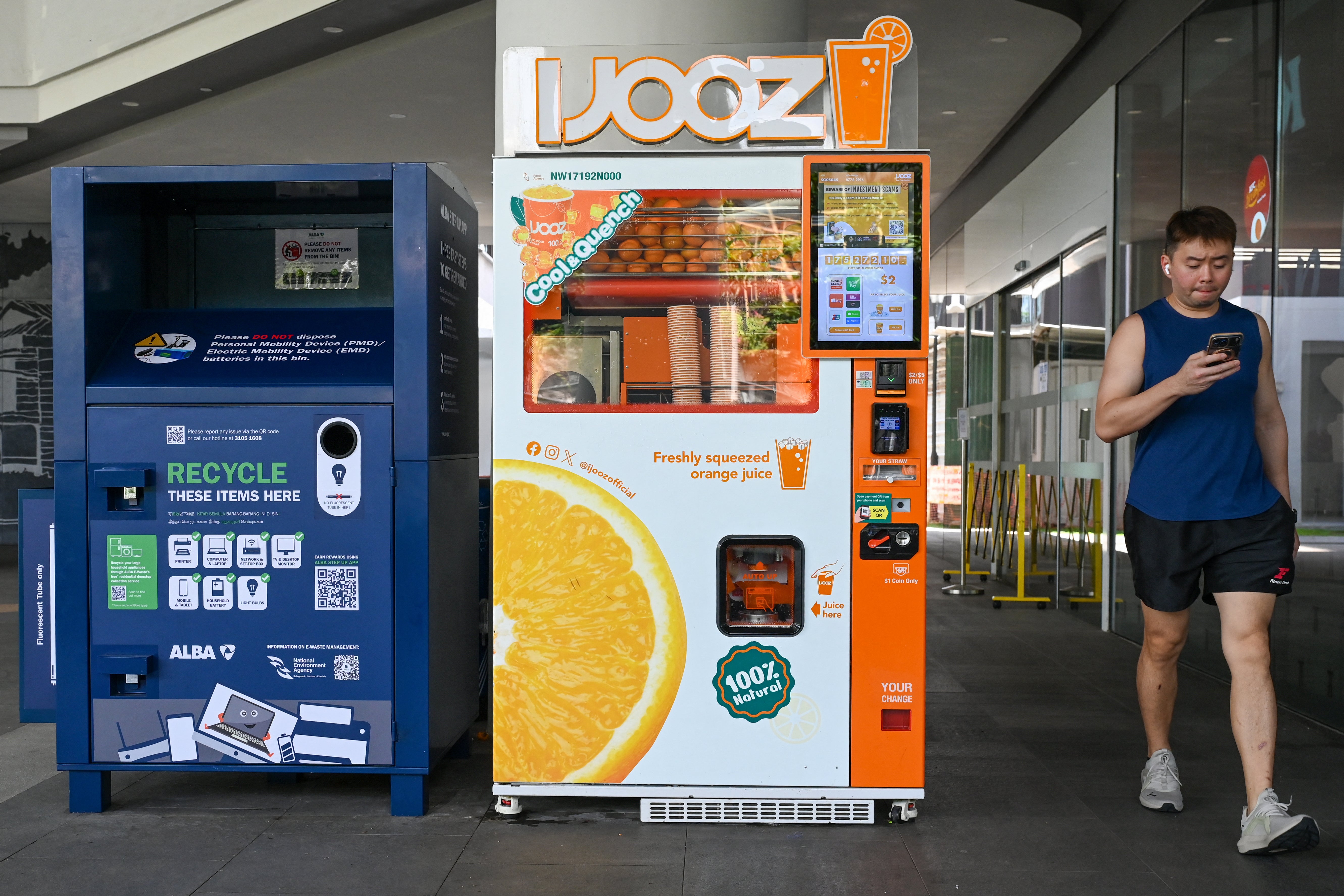 A man walks past an IJOOZ vending machine outside a mall in Singapore on 28 April 2026 (AFP/Getty)