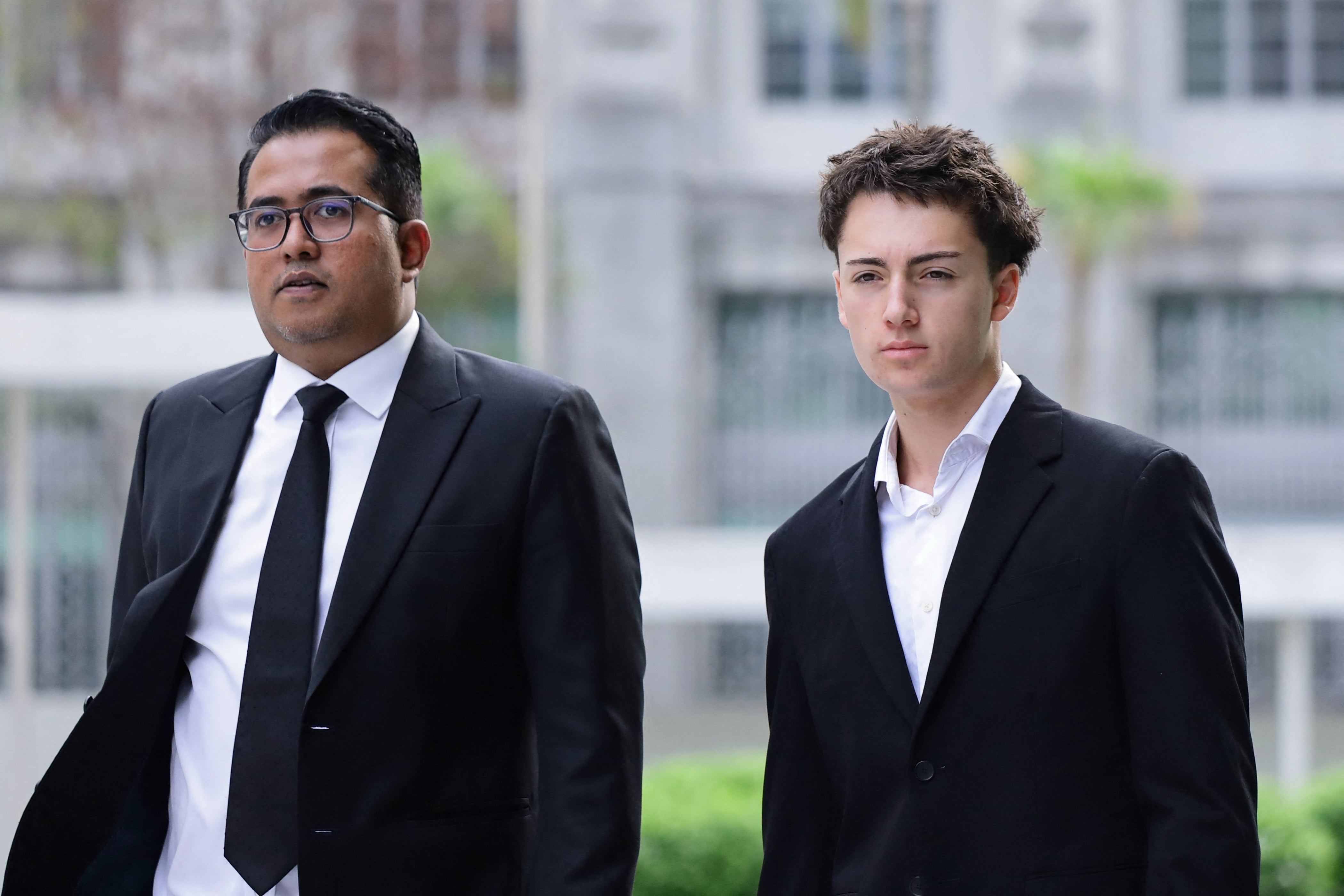 French teenager Didier Gaspard Owen Maximilien (R) and his lawyer arrive at the State Courts in Singapore on 30 July 2026 (AFP/Getty)