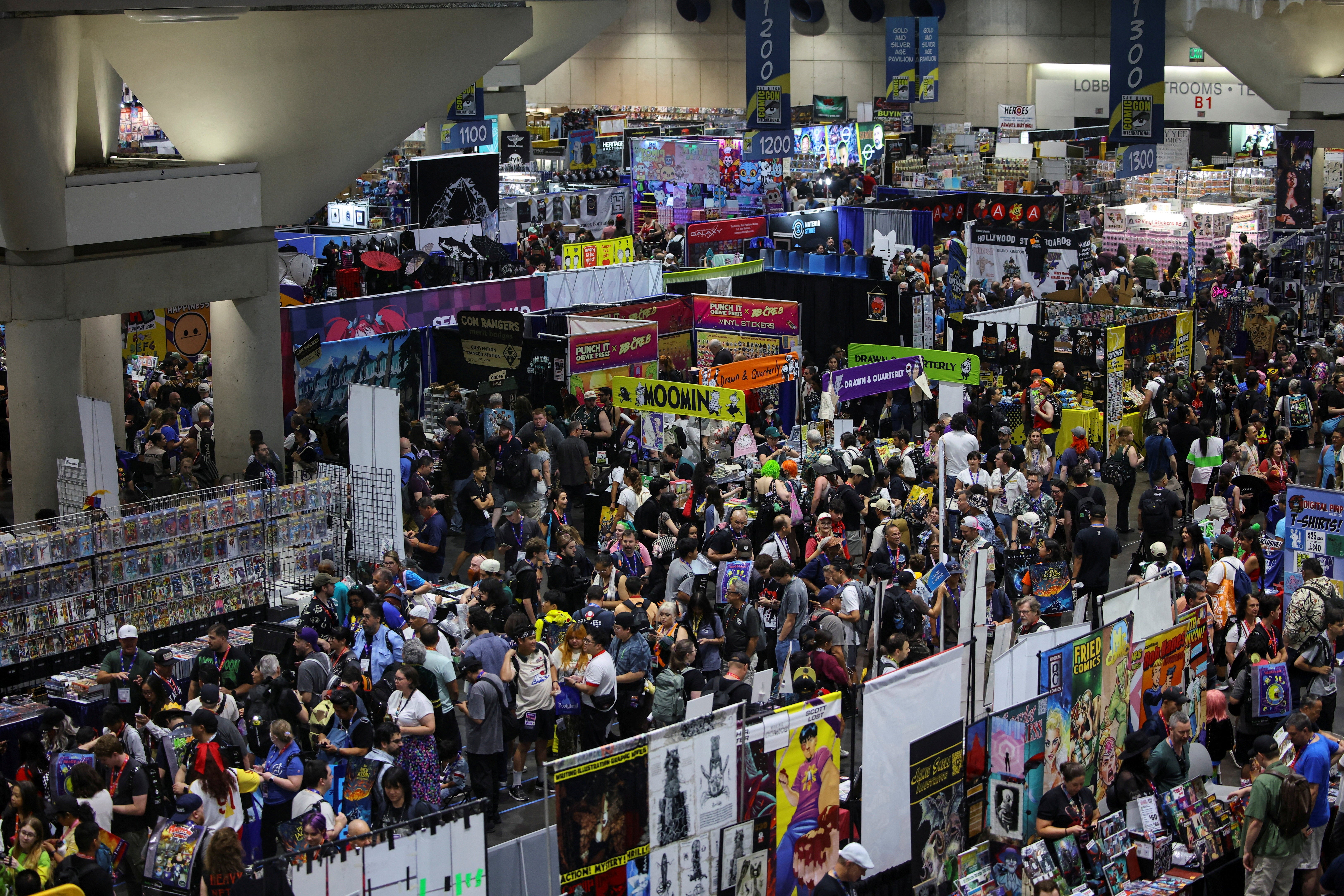 Attendees walk through the exhibition hall during the opening day of Comic-Con International in San Diego